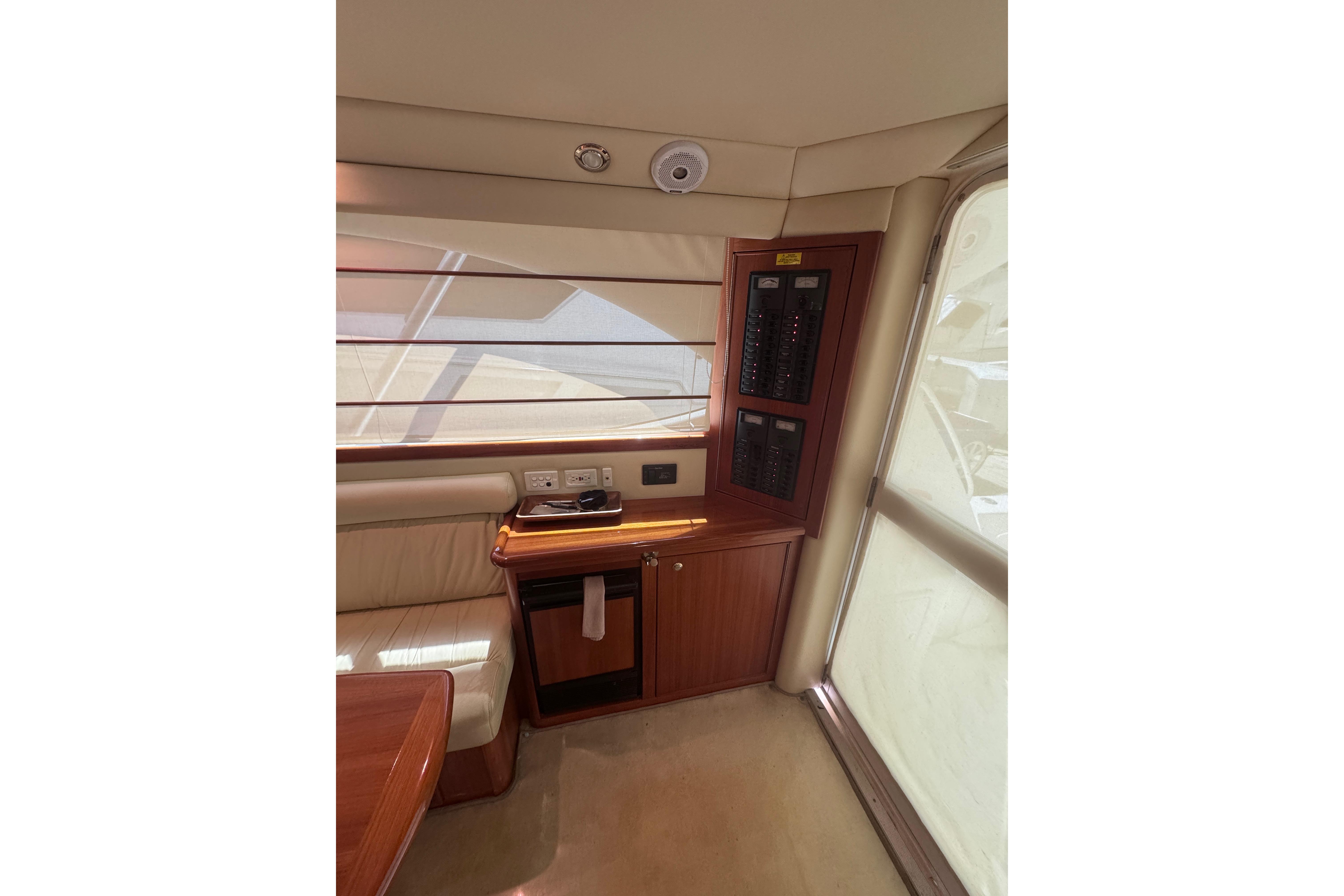 Interior of 2006 Riviera 37 Flybridge yacht with control panel and seating area.