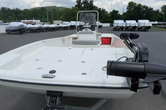 2025 Mako Pro Skiff 17 CC boat in a parking lot, featuring a sleek white deck.