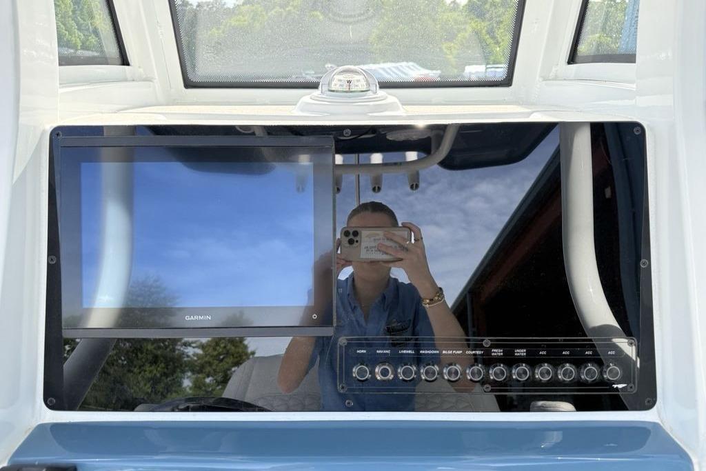 2026 Tidewater 232 LXF boat dashboard with Garmin display and control panel.