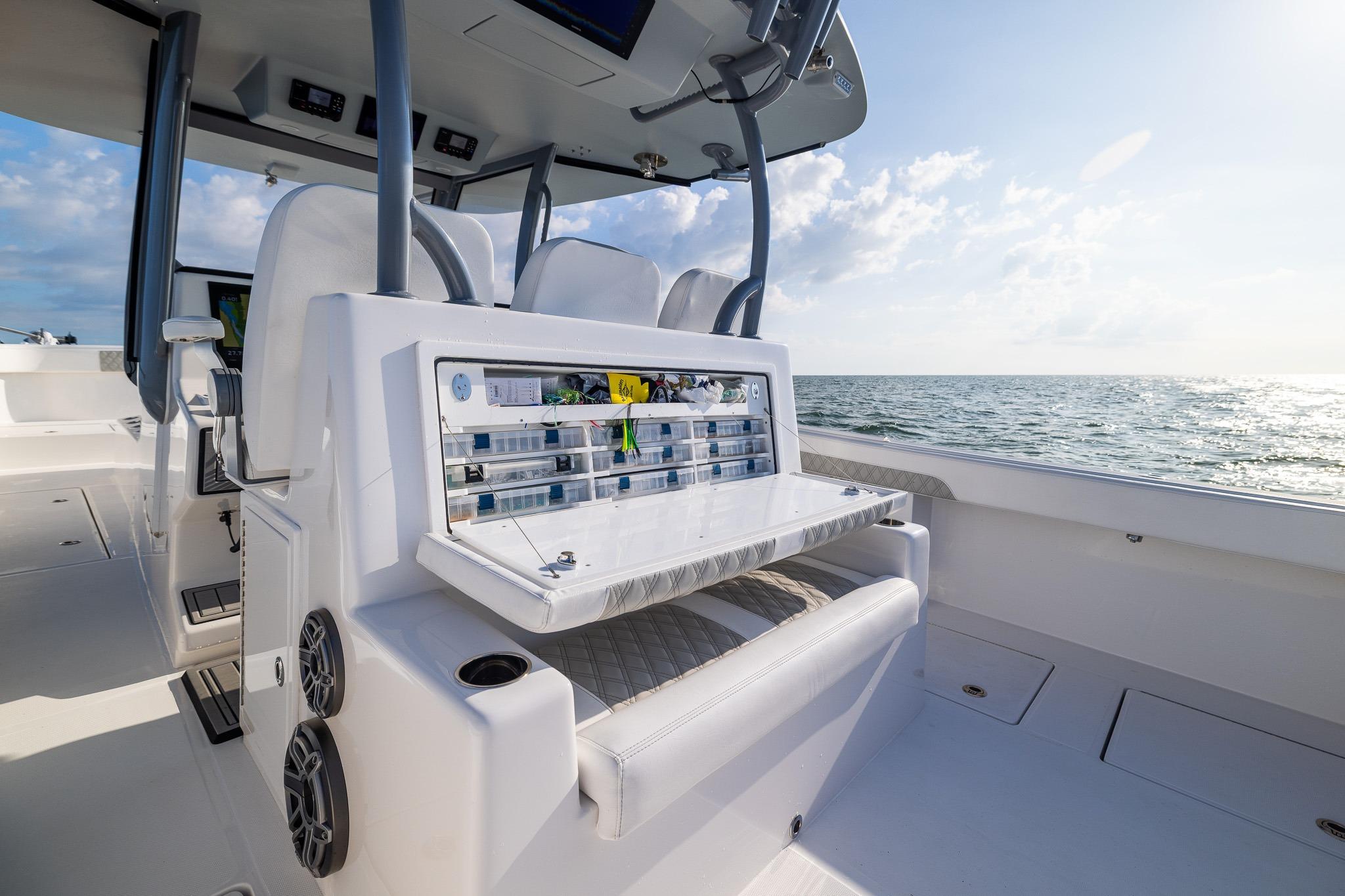 2026 Front Runner 37 Catamaran interior with fishing tackle storage, ocean view in background.