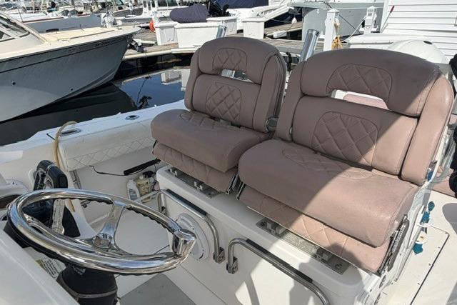 2014 Edgewater 318CC boat interior with dual cushioned seats and steering wheel.