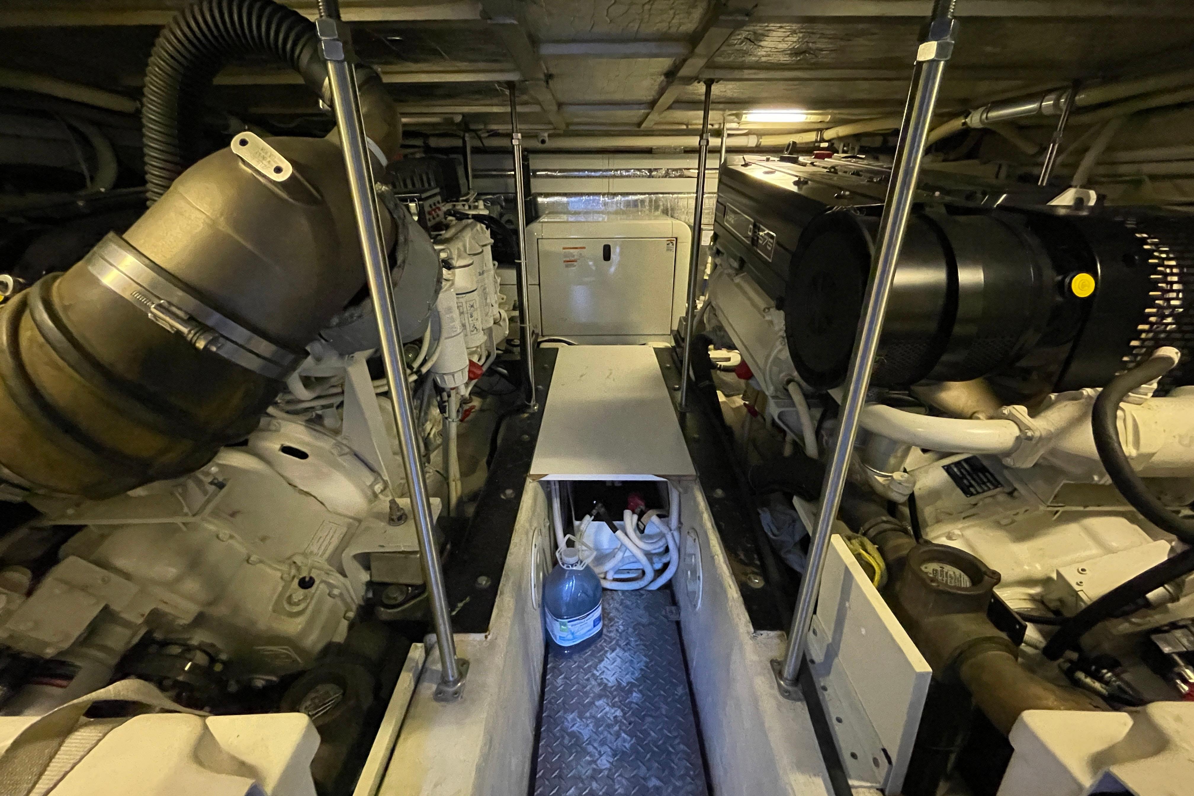 Engine room of 2002 Carver 570 Voyager Pilothouse, showcasing mechanical components and equipment.