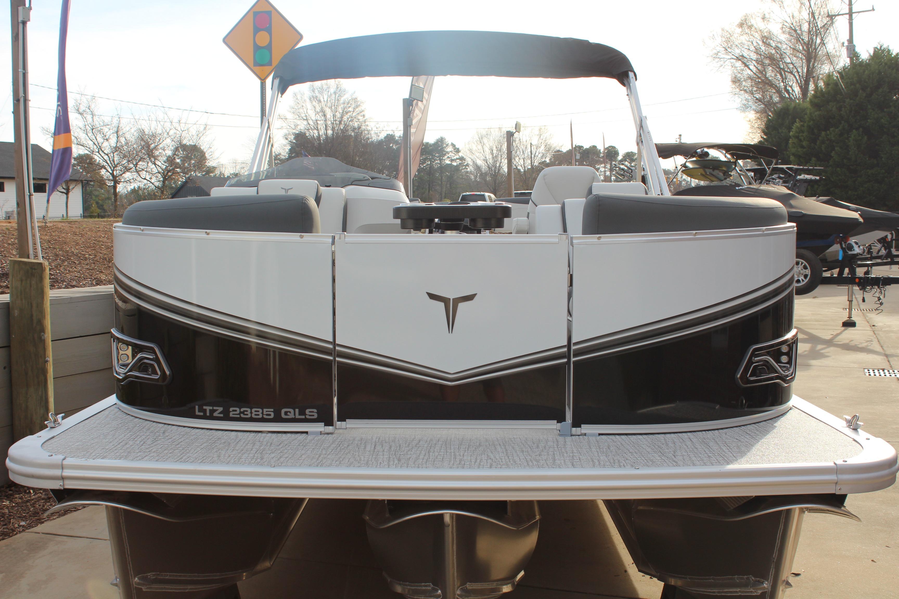 2026 Tahoe Pontoon LTZ boat, sleek design, black and white exterior, docked outdoors.