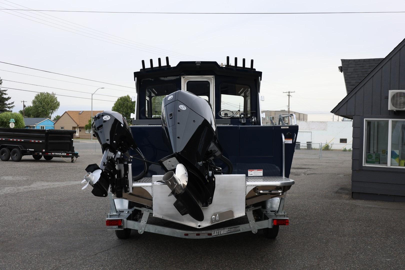 2026 Thunder Jet 24 Alexis Pro boat with dual outboard motors on a trailer.