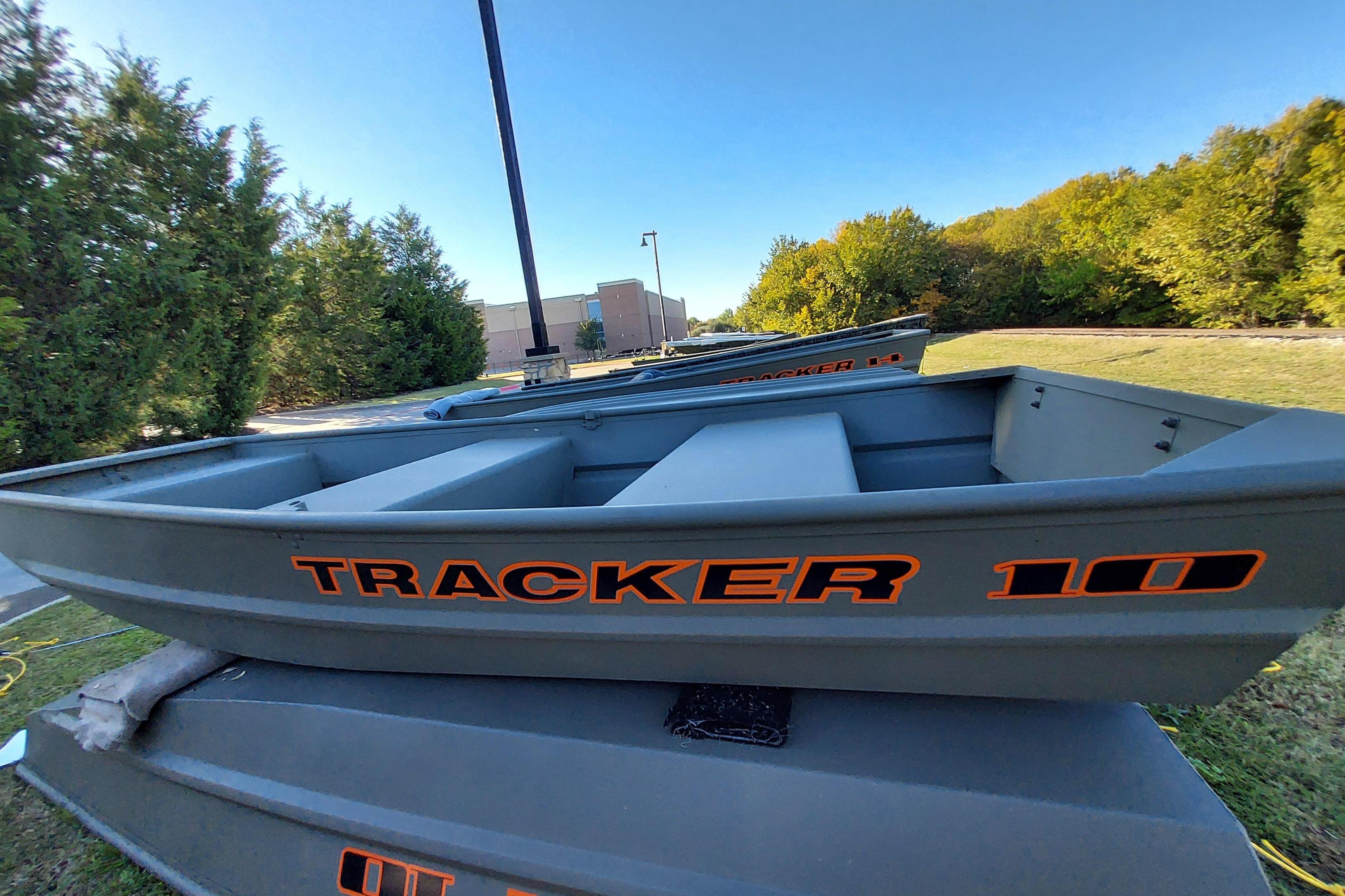 2026 Tracker Grizzly 10 Jon boat displayed outdoors, surrounded by greenery.