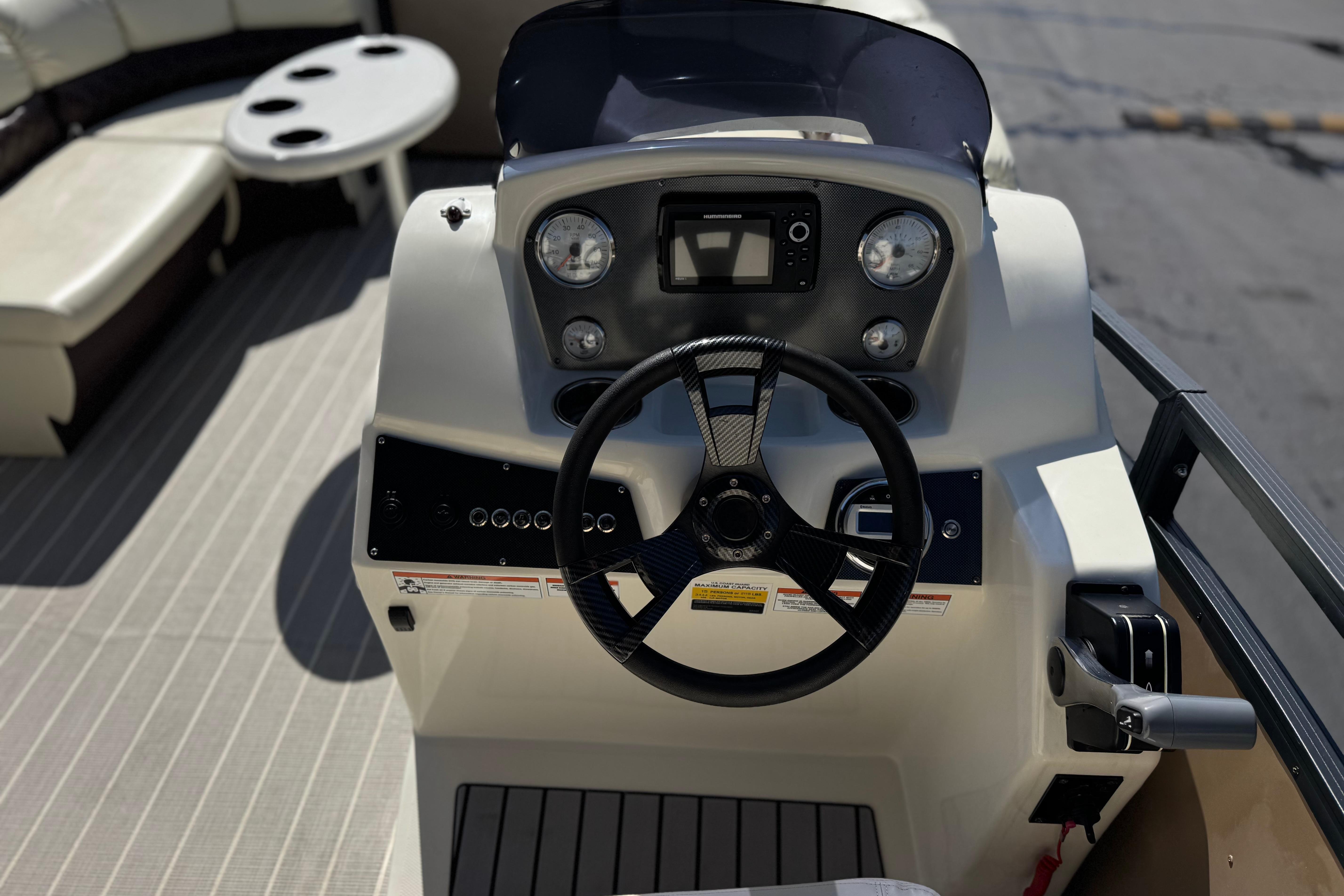 2023 Lexington 623 ST Xtreme boat dashboard with steering wheel and controls.