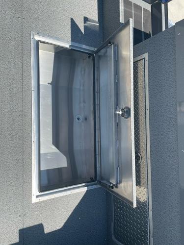 Open storage compartment on 2025 Spartan 240 Maximus Pro vehicle.