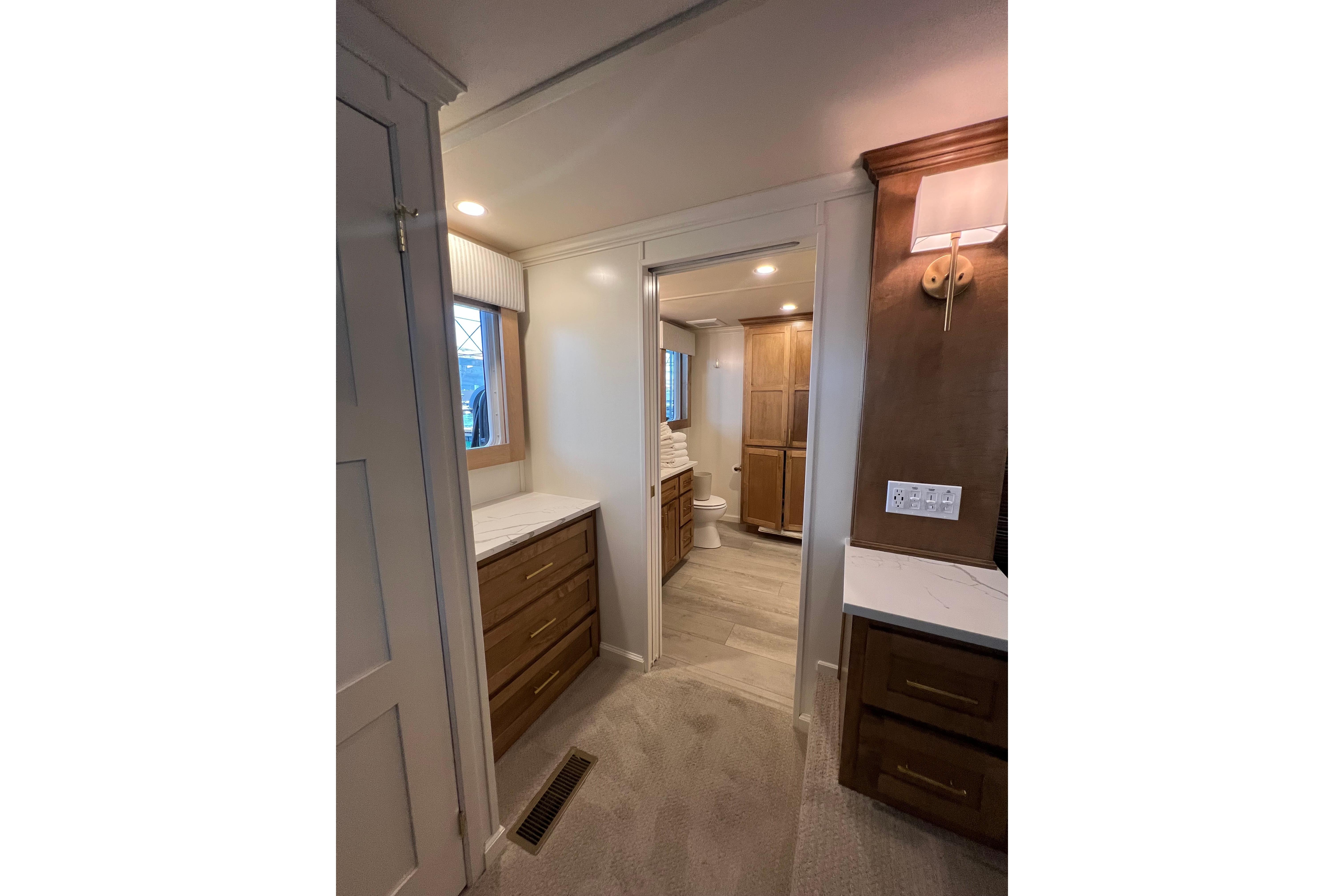 Modern bathroom interior in 2025 Sumerset Excellence Multiple Shares houseboat, featuring wood cabinetry and elegant lighting.