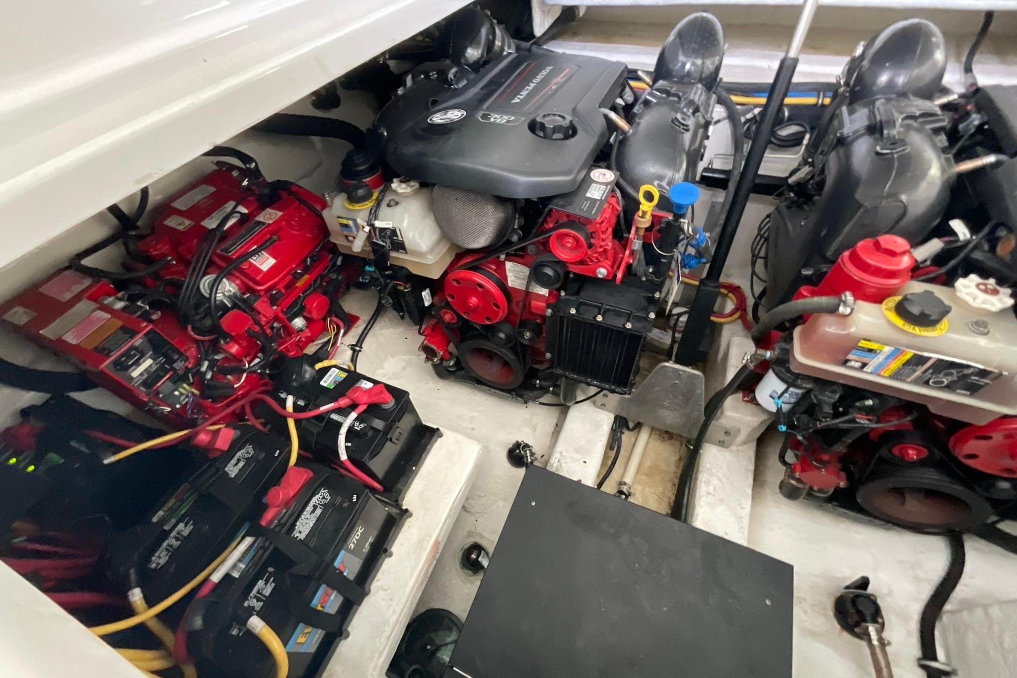 Engine compartment of a 2019 Monterey 335 Sport Yacht, showcasing dual engines and battery setup.