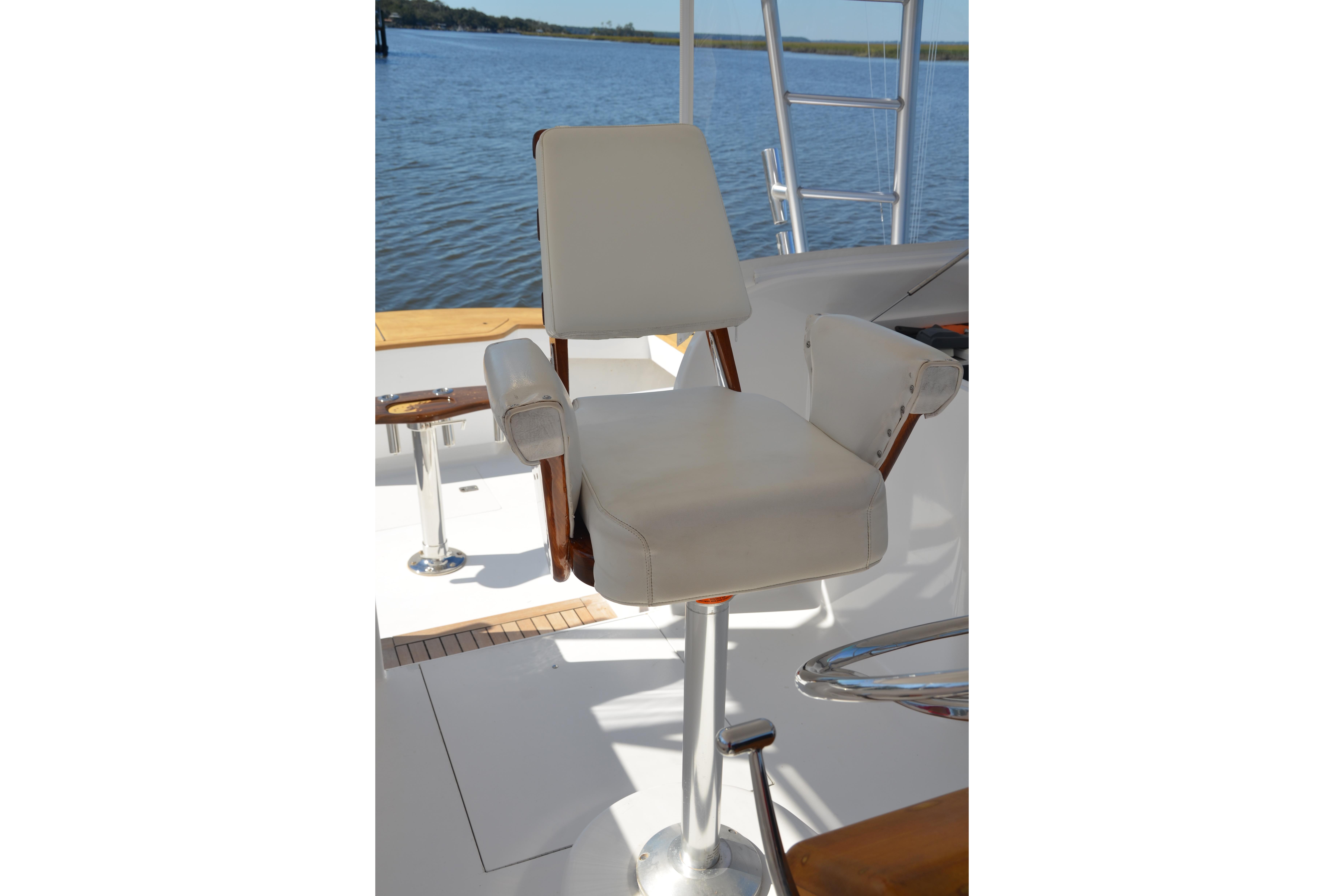 Captain's chair on 2006 Custom Carolina Heritage Express boat, overlooking serene water.