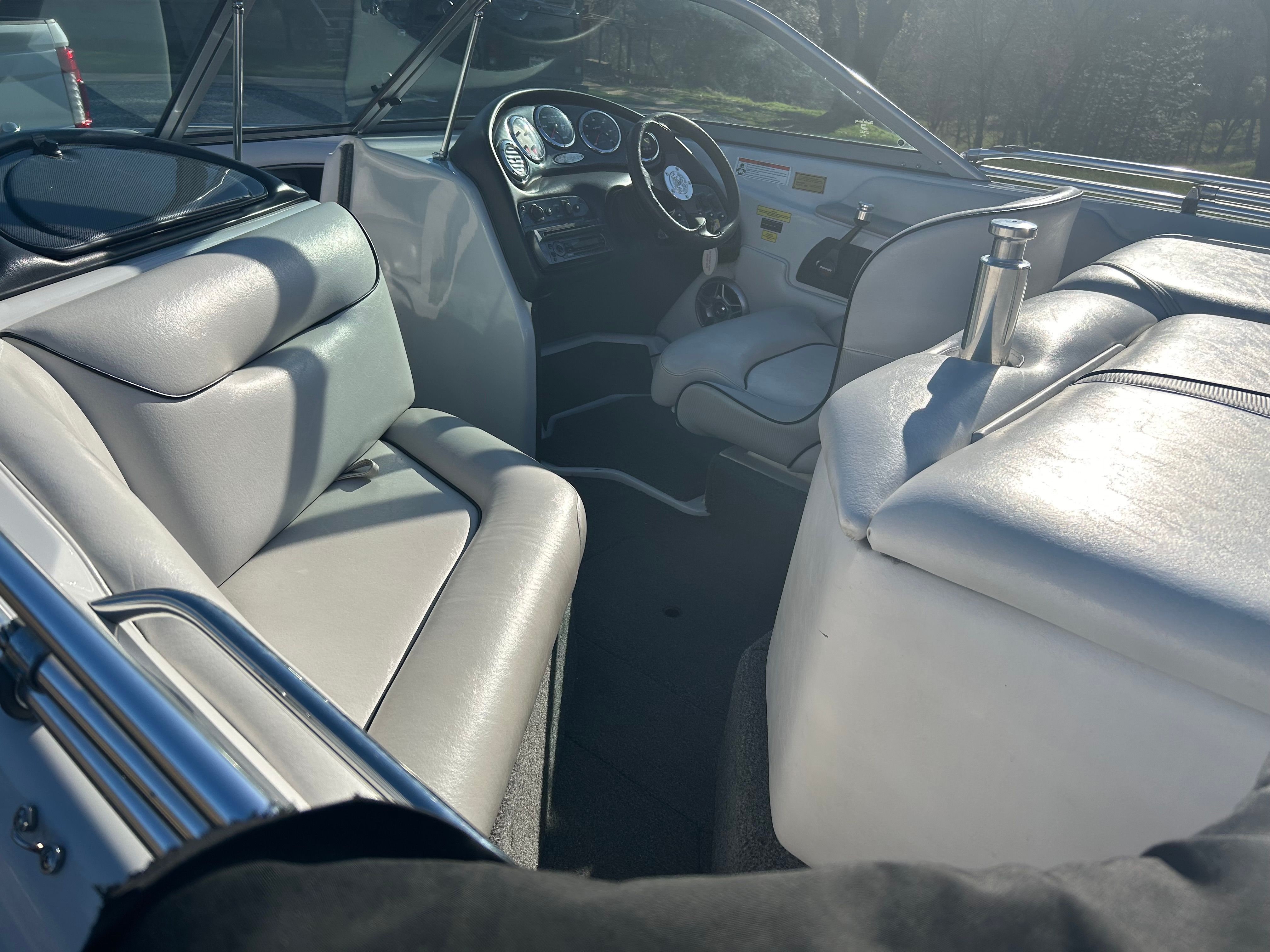 Interior of a Sanger boat with gray leather seats and dashboard.