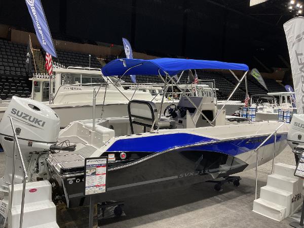 2025 Starcraft SVX 211 OB CC boat with Suzuki engine, displayed indoors.