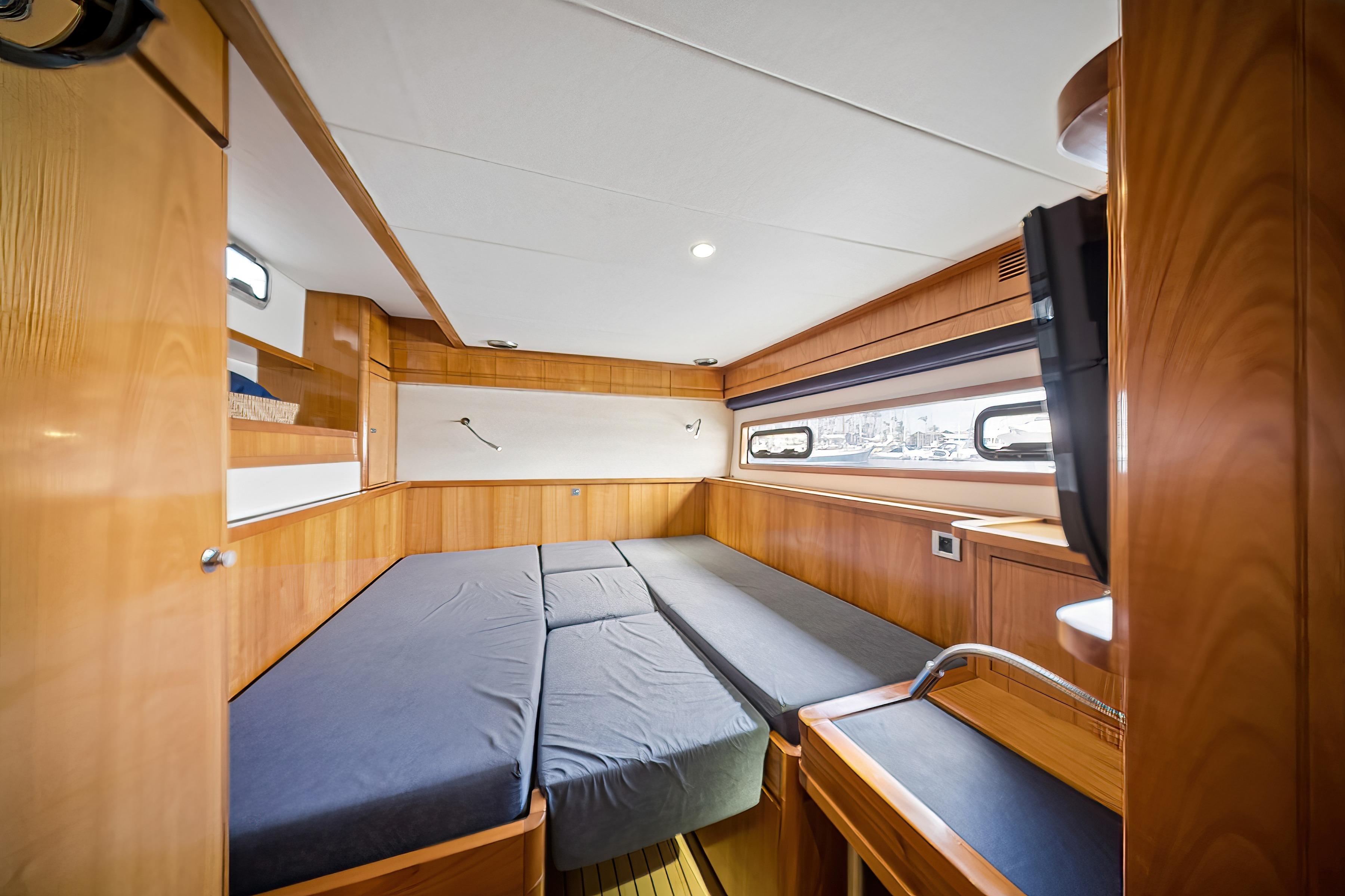 Interior of 2009 Catana 65 yacht cabin with wooden finish and modern amenities.