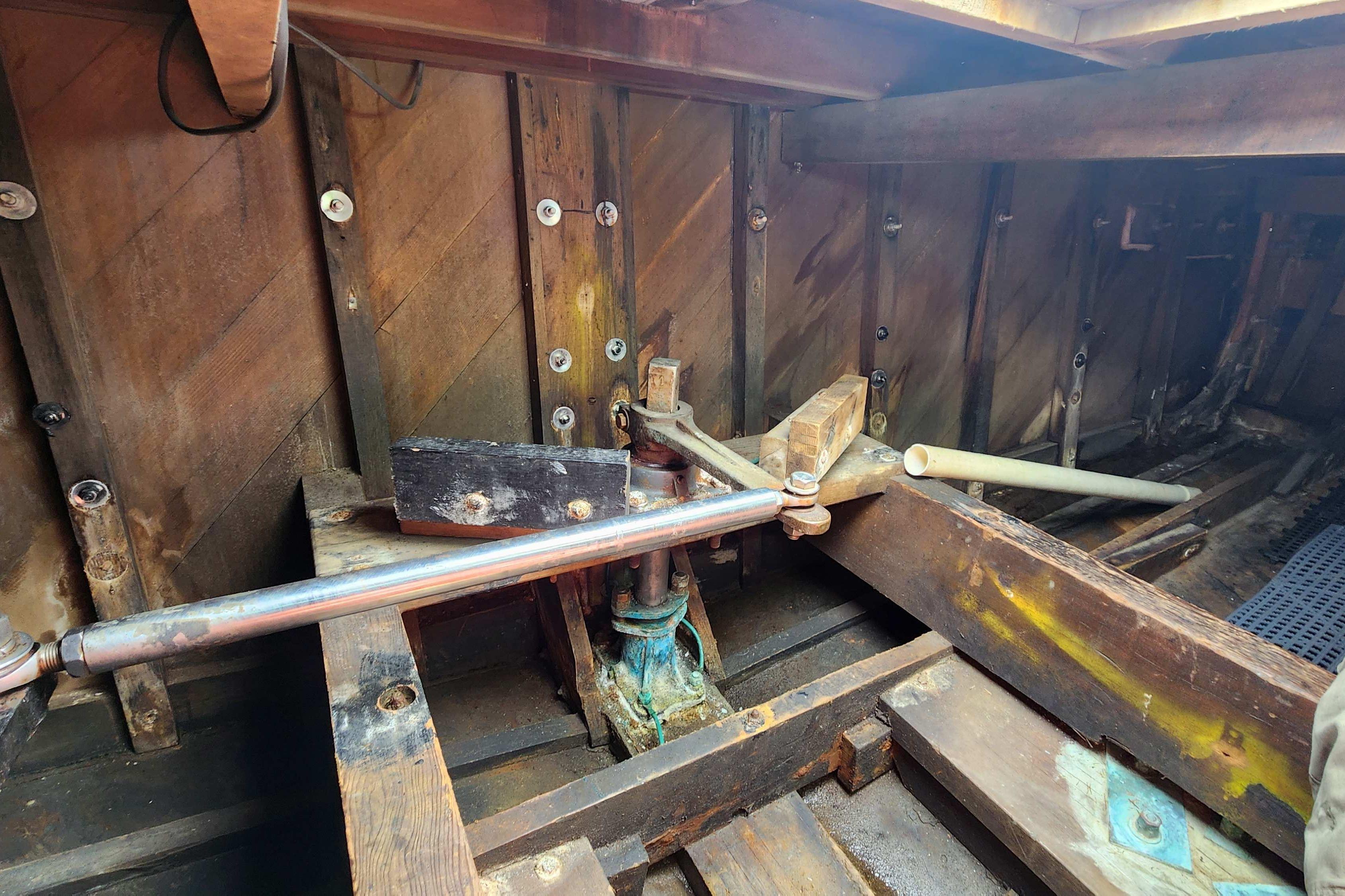 Interior view of a 1964 Grandy Tour Boat's wooden structure and mechanical components.