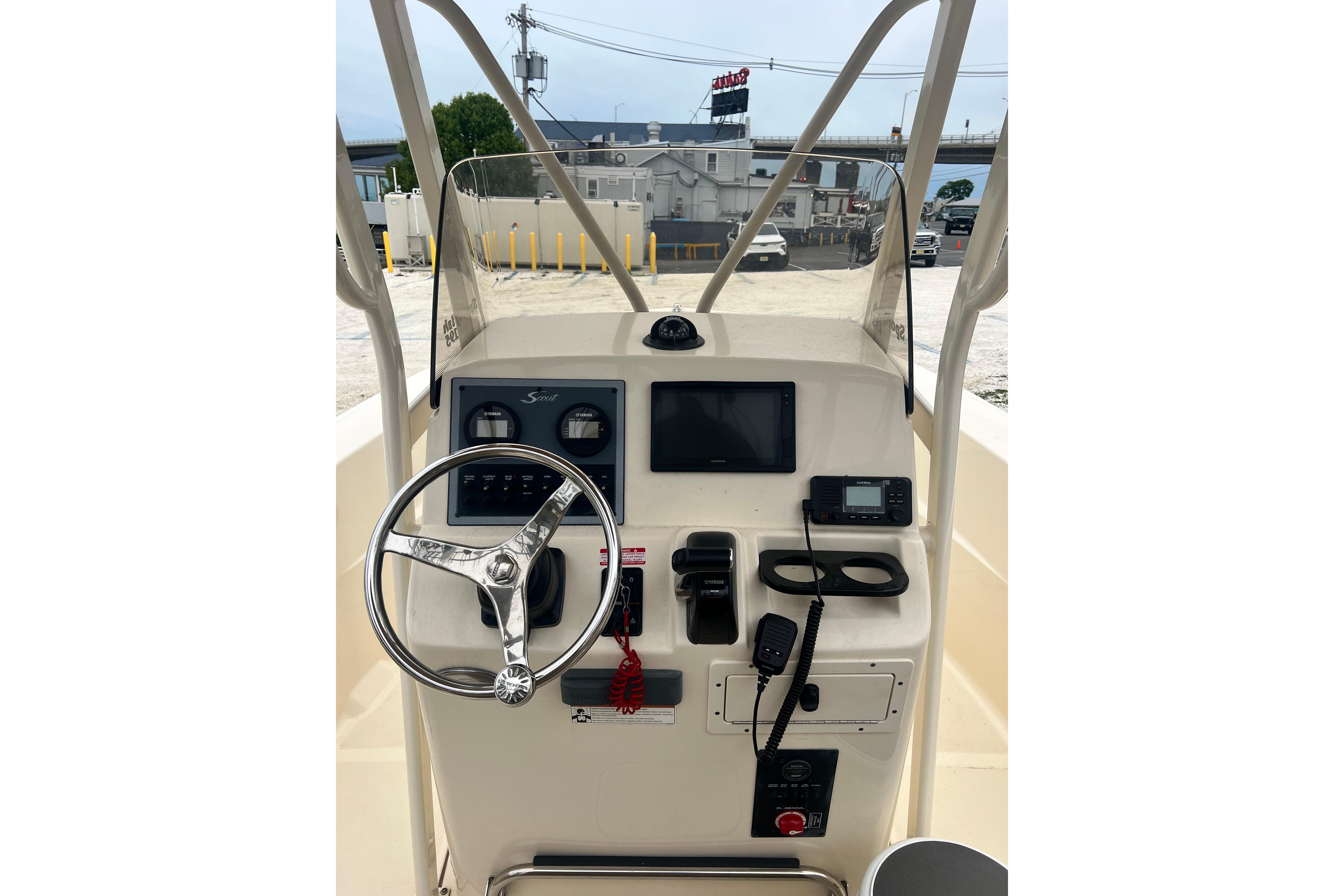 2020 Scout 195 Sportfish boat dashboard with steering wheel and navigation controls.