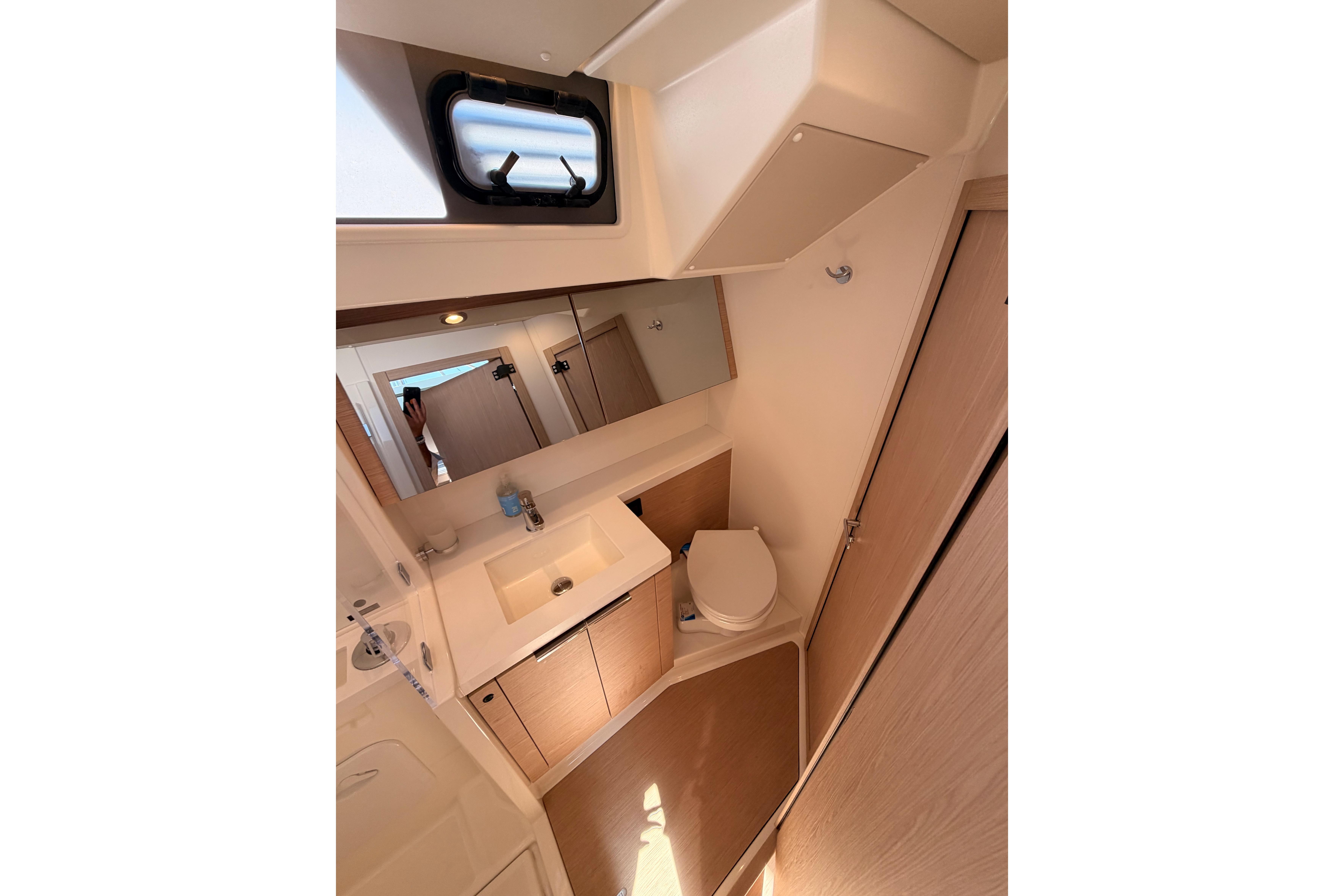 Modern bathroom interior of 2022 Beneteau Oceanis Yacht 54, featuring sleek design and fixtures.