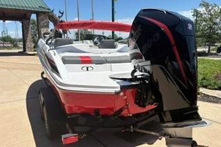 2026 Tahoe T21 boat with powerful outboard motor, parked on a sunny day.