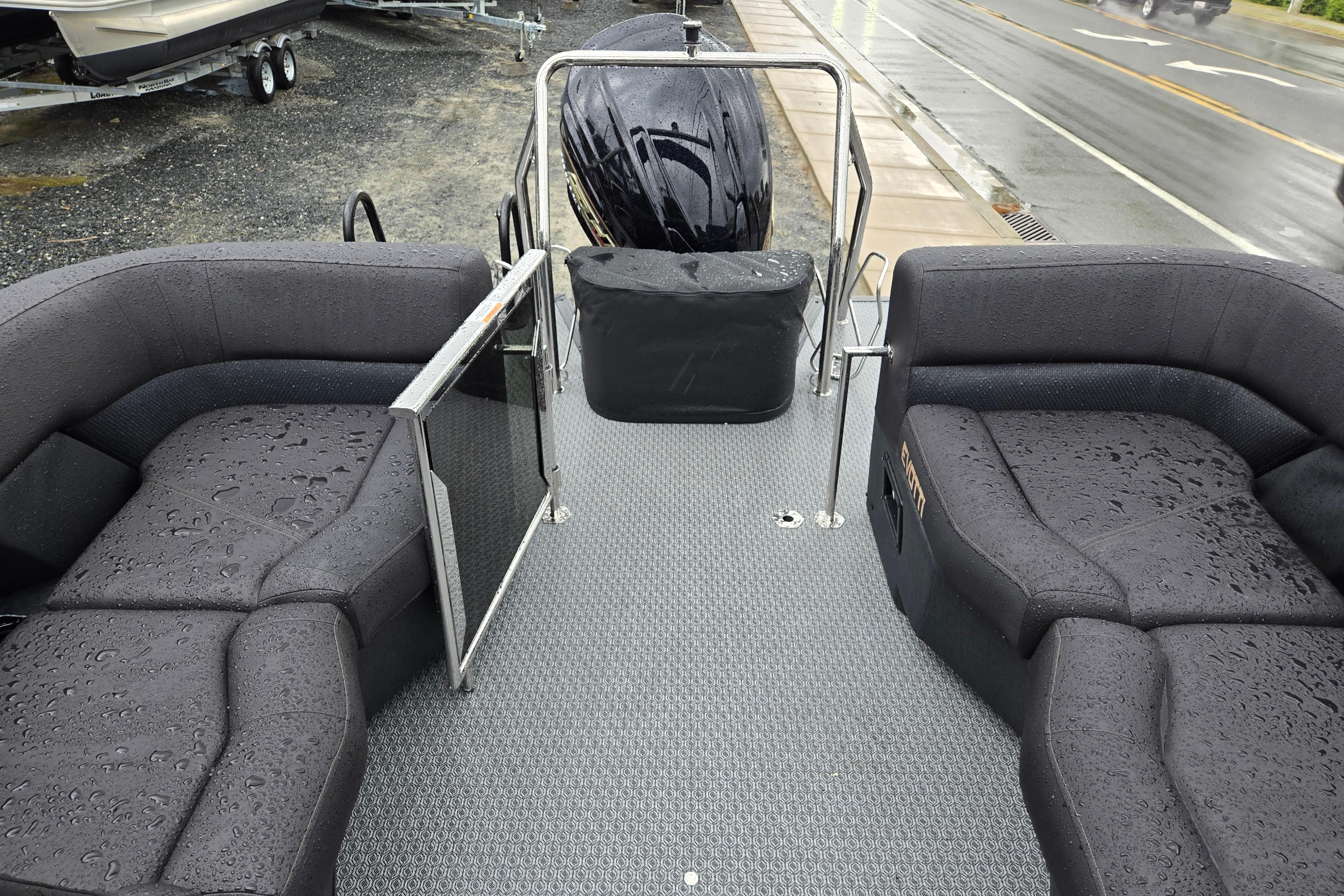Wet deck of 2026 Evotti 721QL boat with cushioned seating and railing.
