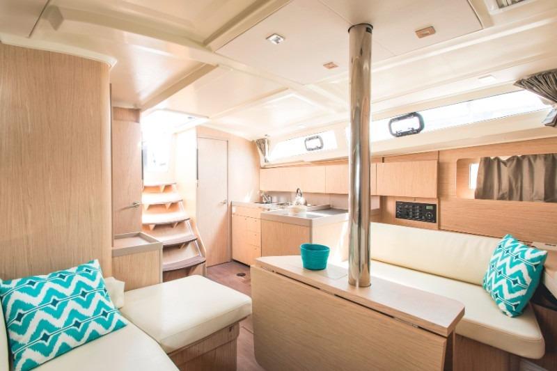 Interior of 2019 Beneteau Oceanis 41.1 yacht, featuring modern kitchen and cozy seating area.