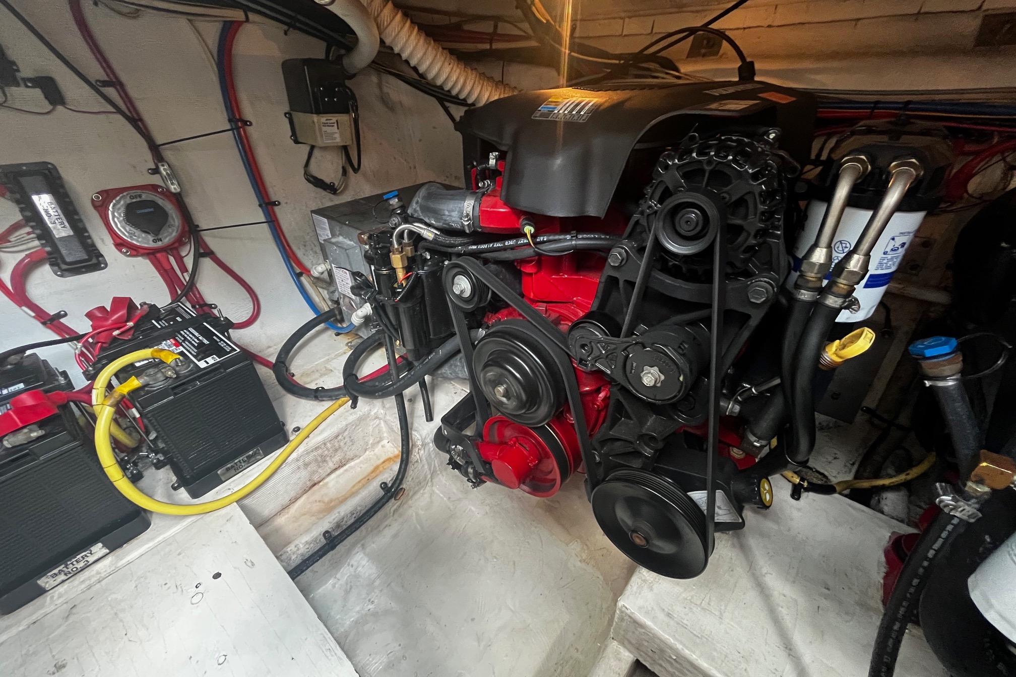 Engine compartment of a 2004 Cruisers Yachts 280 CXi Express, showcasing detailed mechanical components.