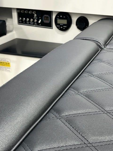 2023 Vision Marine Technologies Fantail 217 interior with sleek, modern dashboard and textured seating.