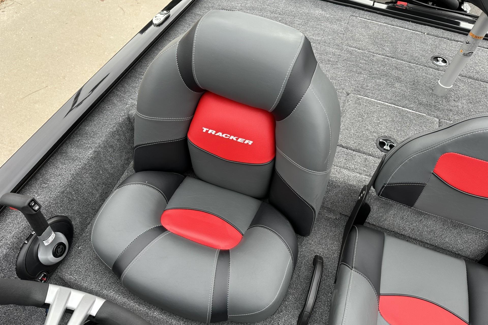 2025 Tracker Savage 215 boat interior with gray and red cushioned seats.