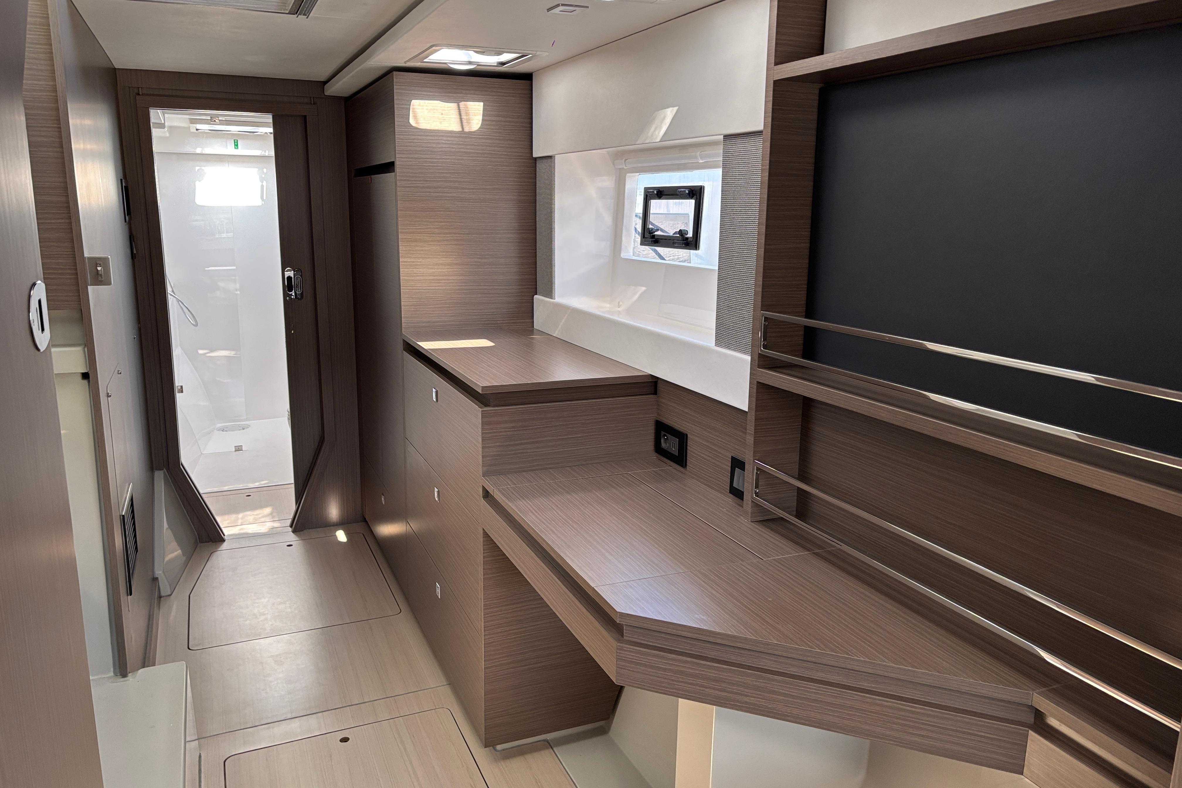 Modern interior of 2025 Leopard 42 yacht with sleek wood finishes and ample storage.