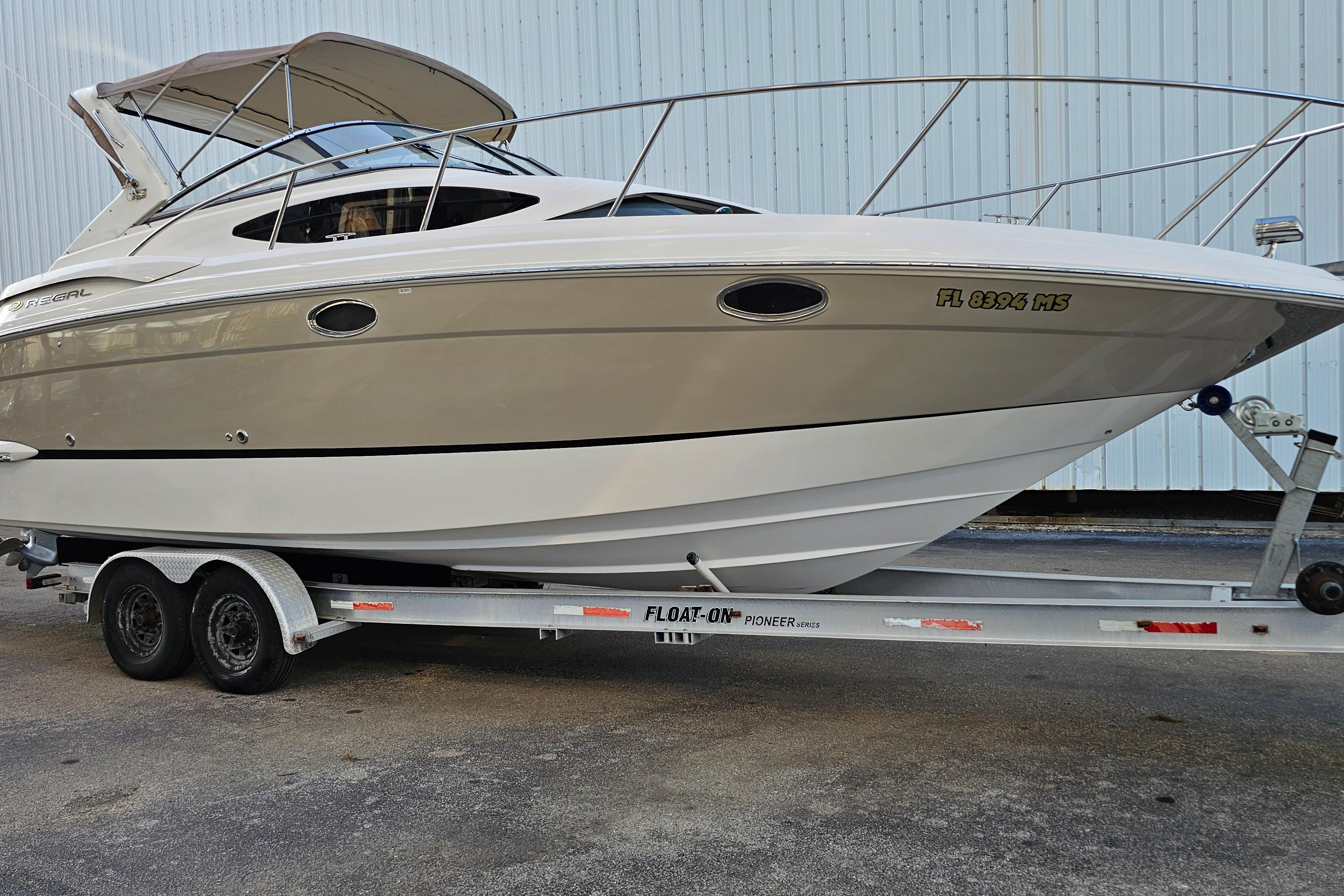 2005 Regal 3060 Window Express boat on trailer, side view.