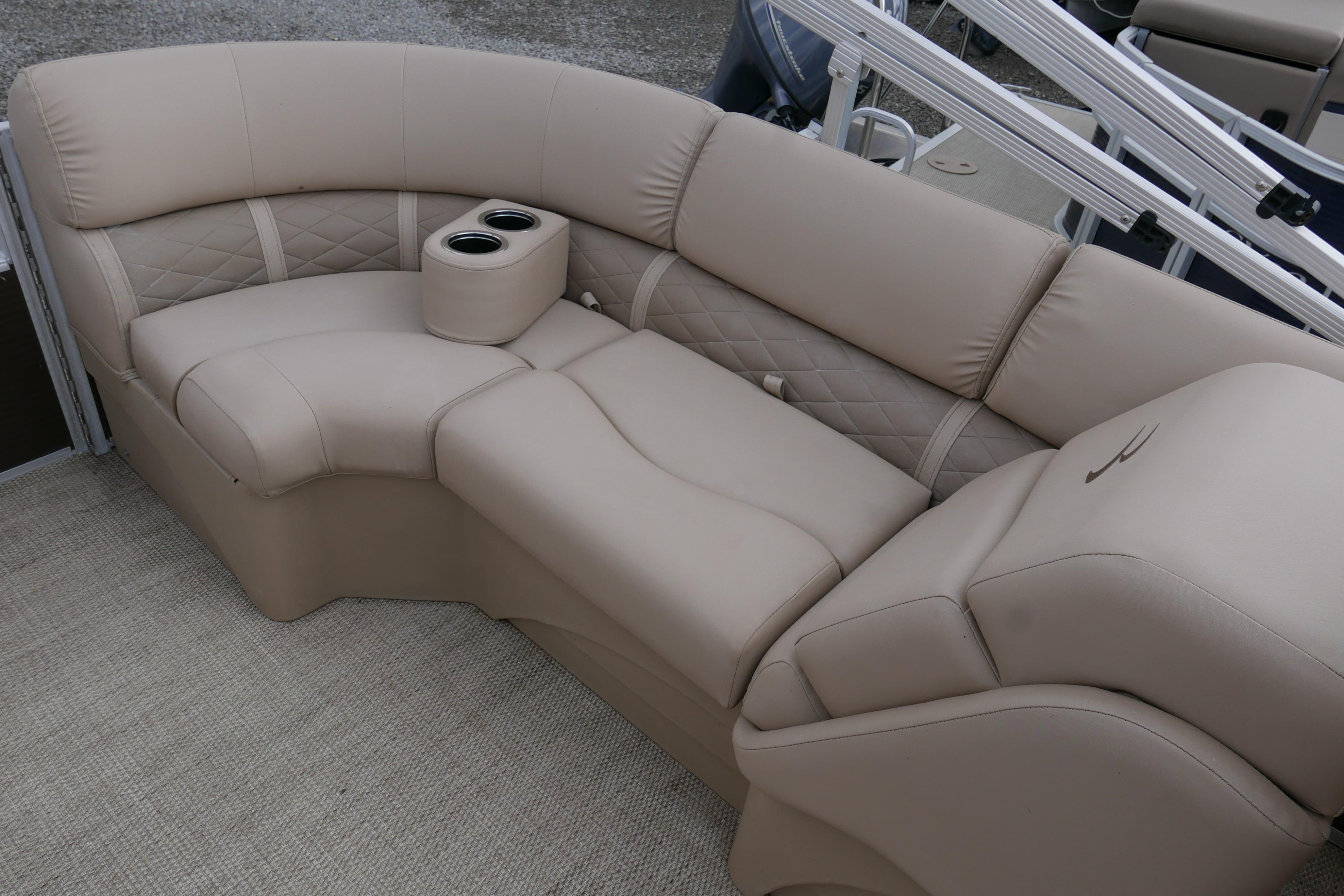 Luxurious beige seating on a 2018 Bennington 22 SSRX pontoon boat with cup holders.