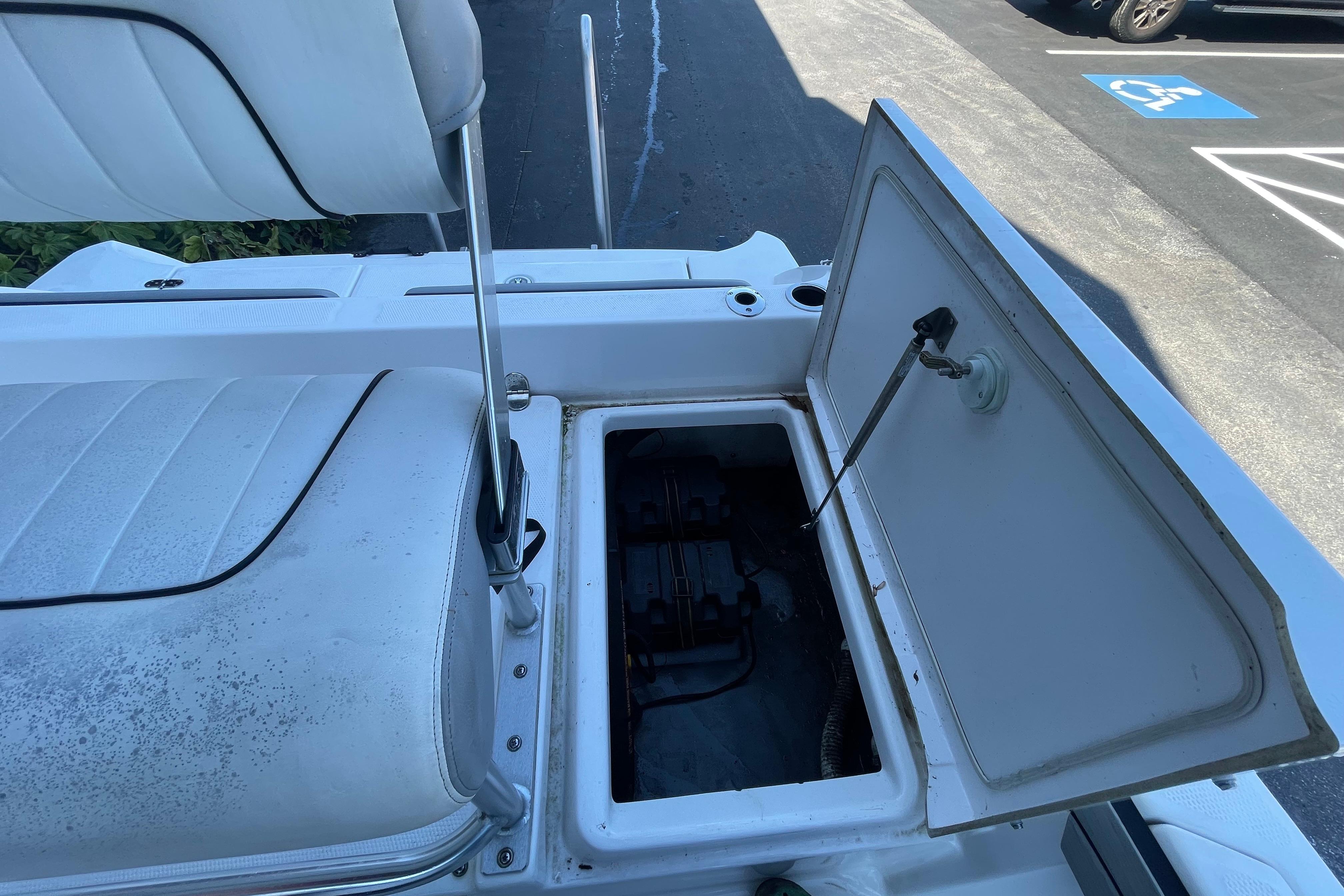 Open storage compartment on 2021 Yamaha Boats 195 FSH Sport, showcasing interior details.