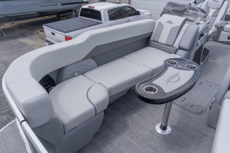 2026 SunCatcher Elite 326 SL pontoon boat interior with plush seating and cupholder table.