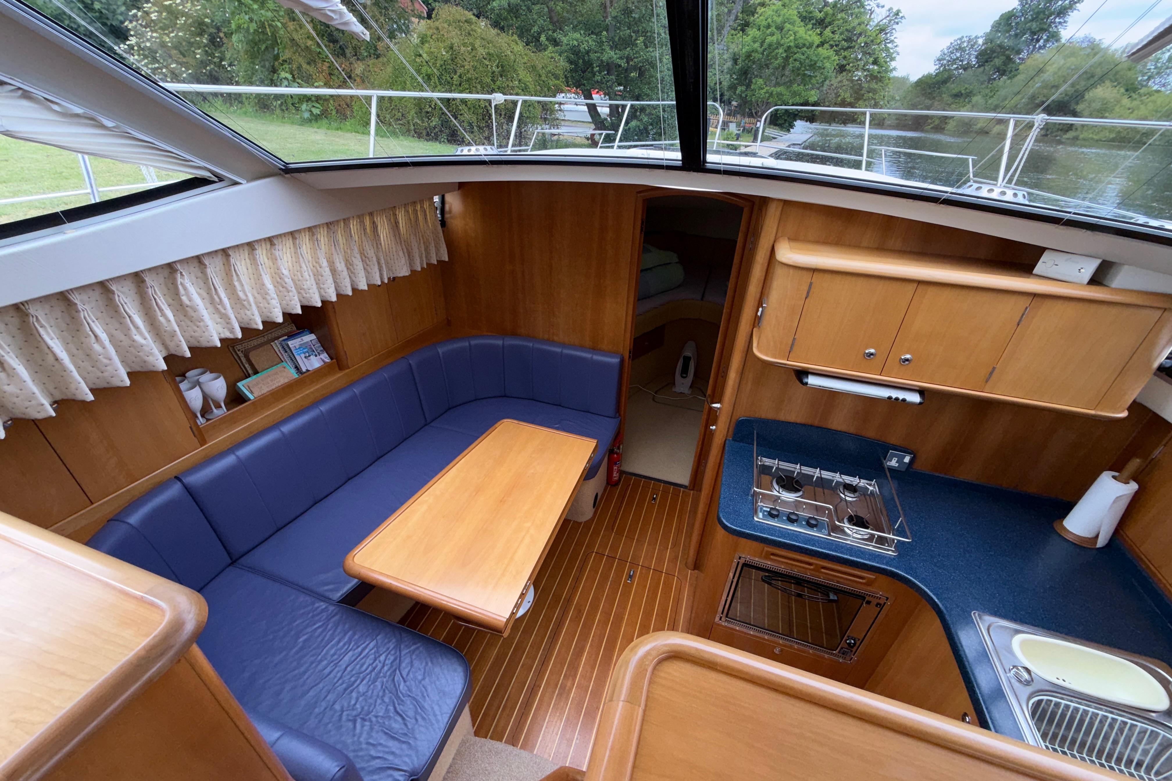Interior of a 2004 Broom 42 CL boat with seating and kitchenette.