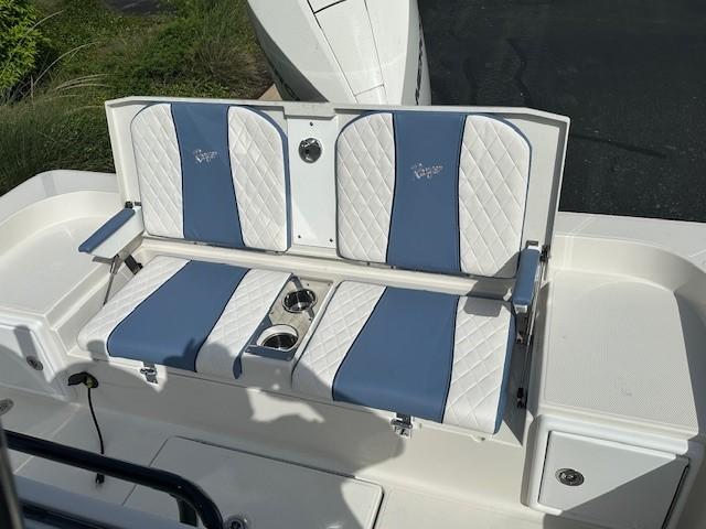 2025 Ranger 2360 Bay boat seating with blue and white cushioned design and cup holders.