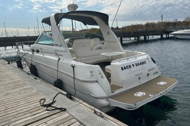 2000 Sea Ray Sundancer 310 docked at marina, rear view with open cockpit.