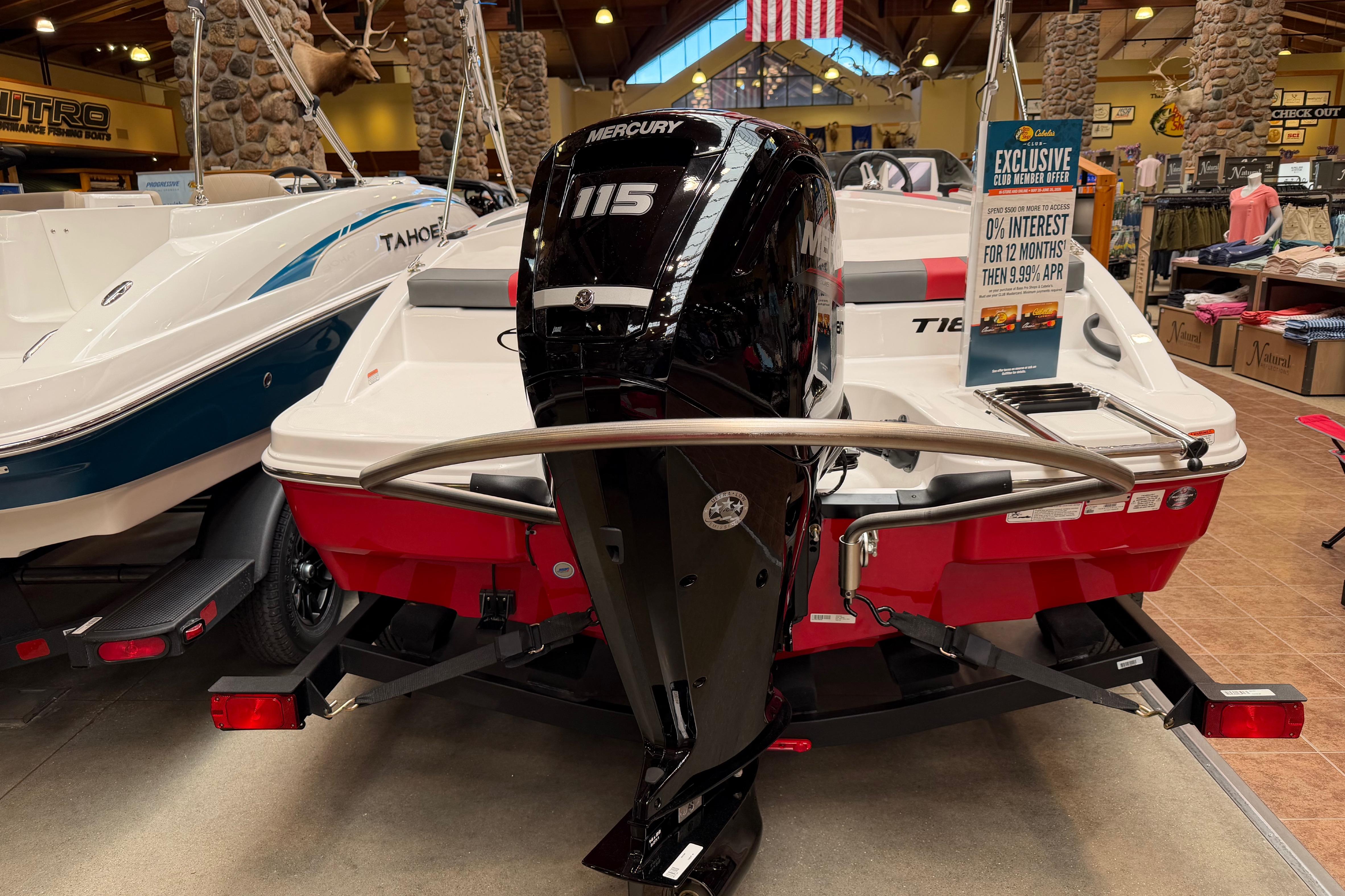 2026 Tahoe T18 boat with Mercury 115 engine displayed in a showroom.