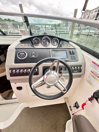 2015 Sea Ray 260 Sundancer helm with gauges and controls at marina.
