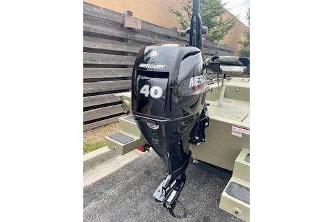 2026 Tracker Grizzly 1654 T Sportsman with Mercury 40 outboard motor, parked outdoors.