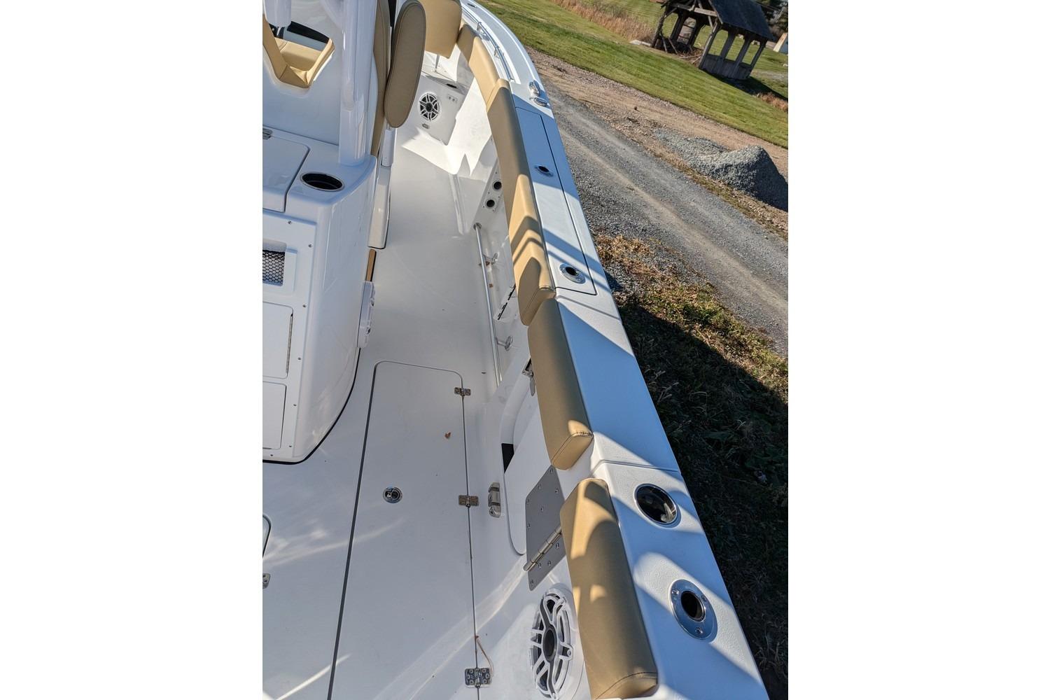 2025 Sportsman Open 282 Center Console boat interior with tan seating and cup holders.