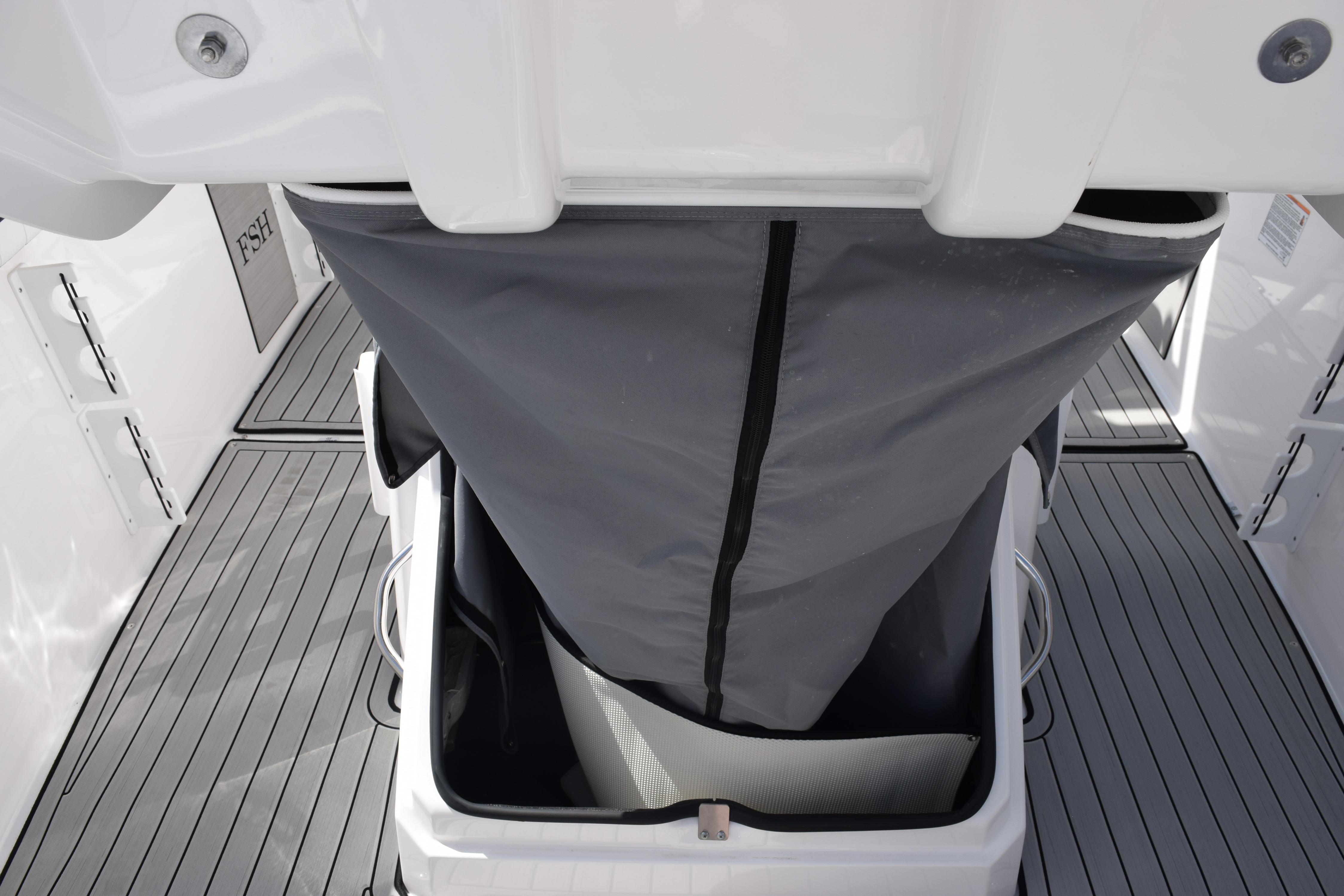 2026 Yamaha Boats 255 FSH Sport H storage compartment with gray cover on deck.