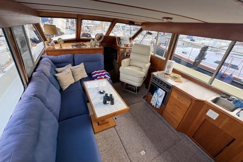 Interior of 1987 Tollycraft 34 Sundeck Motor Yacht with cozy seating and helm.