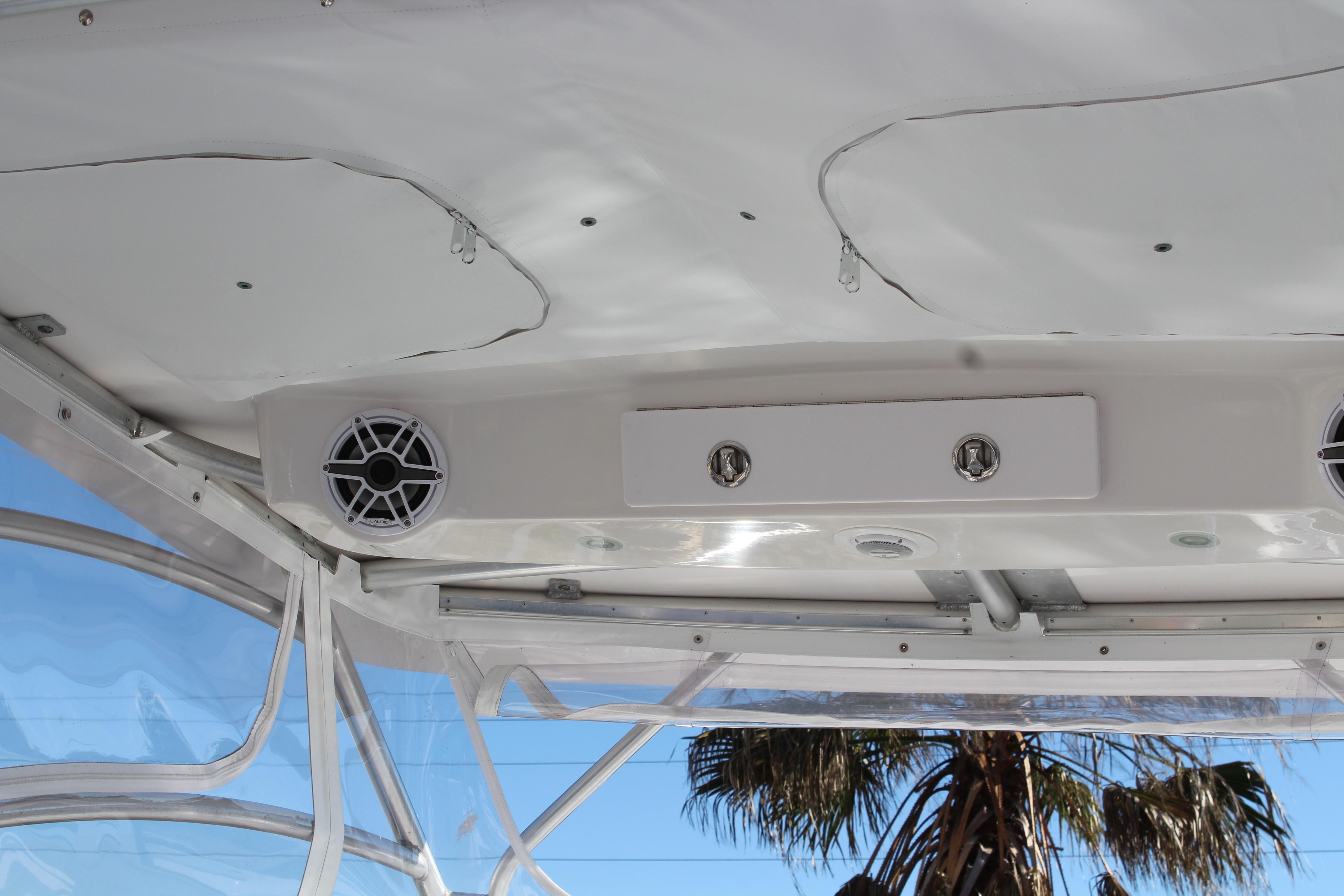 2006 Pro-Line 32 Express boat interior with speakers and palm tree view.