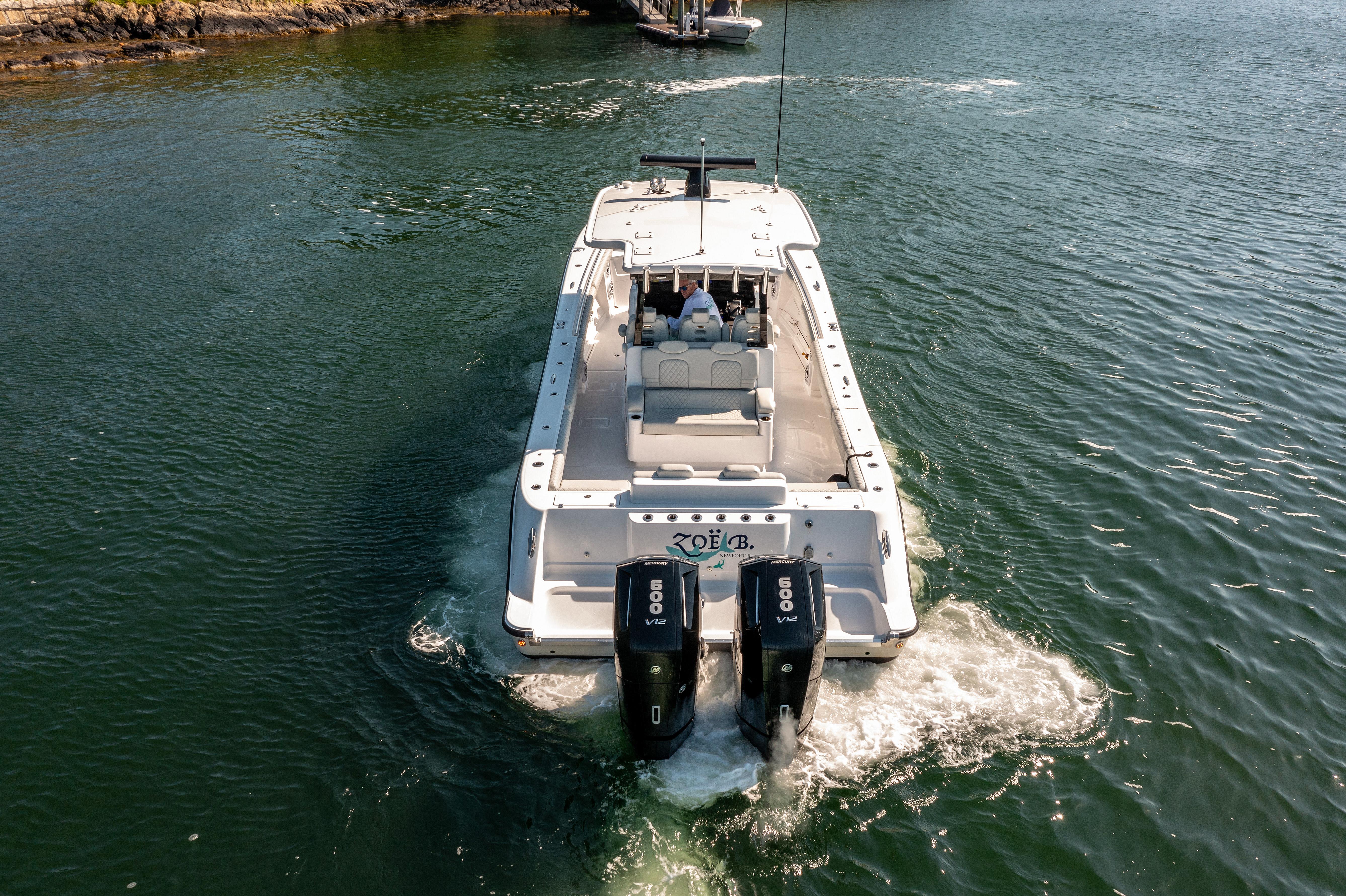2024 HCB 39 Speciale boat cruising on water with twin outboard engines.
