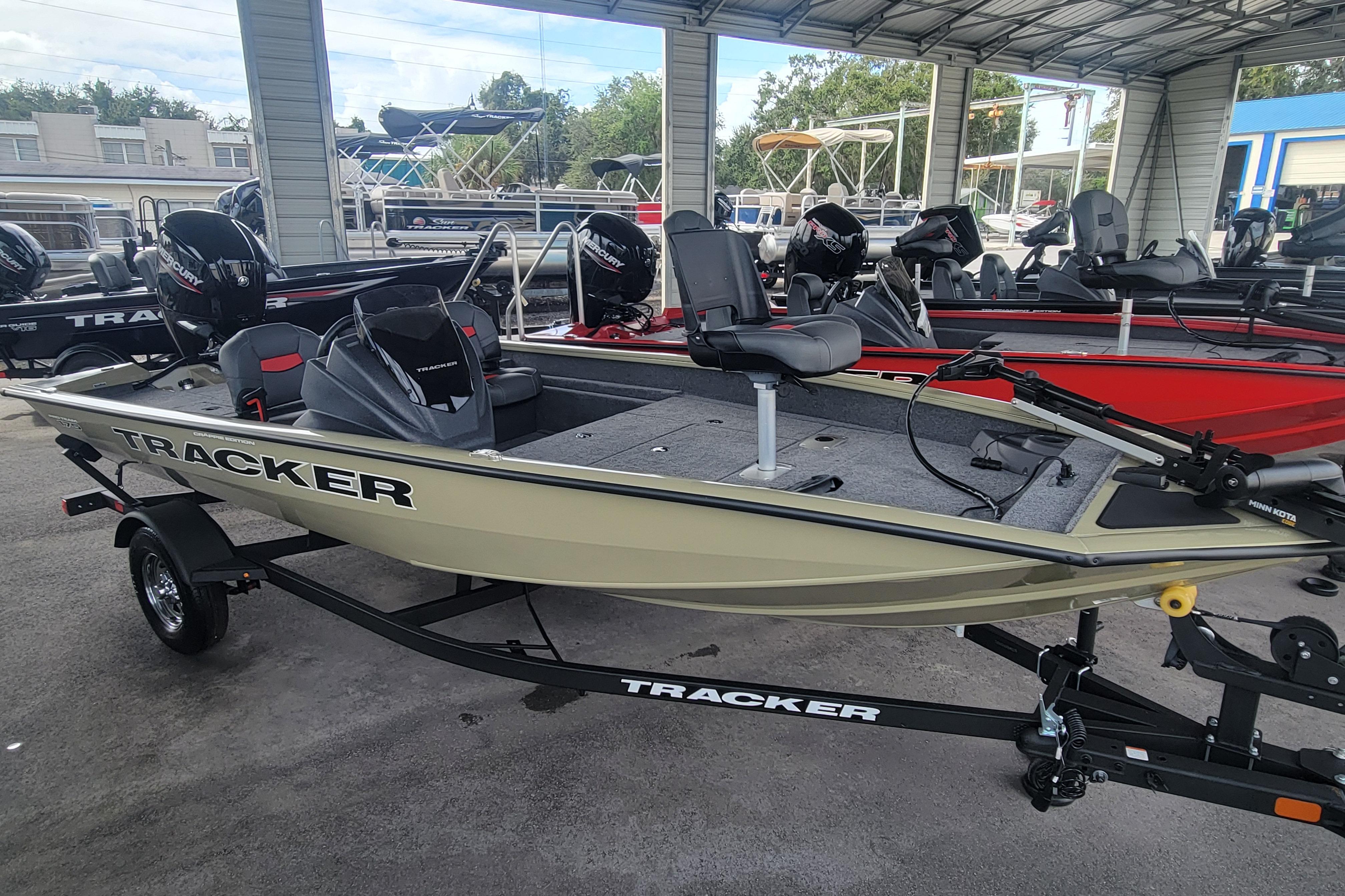 2026 Tracker Pro Team 175 Crappie Edition boat on trailer in showroom.