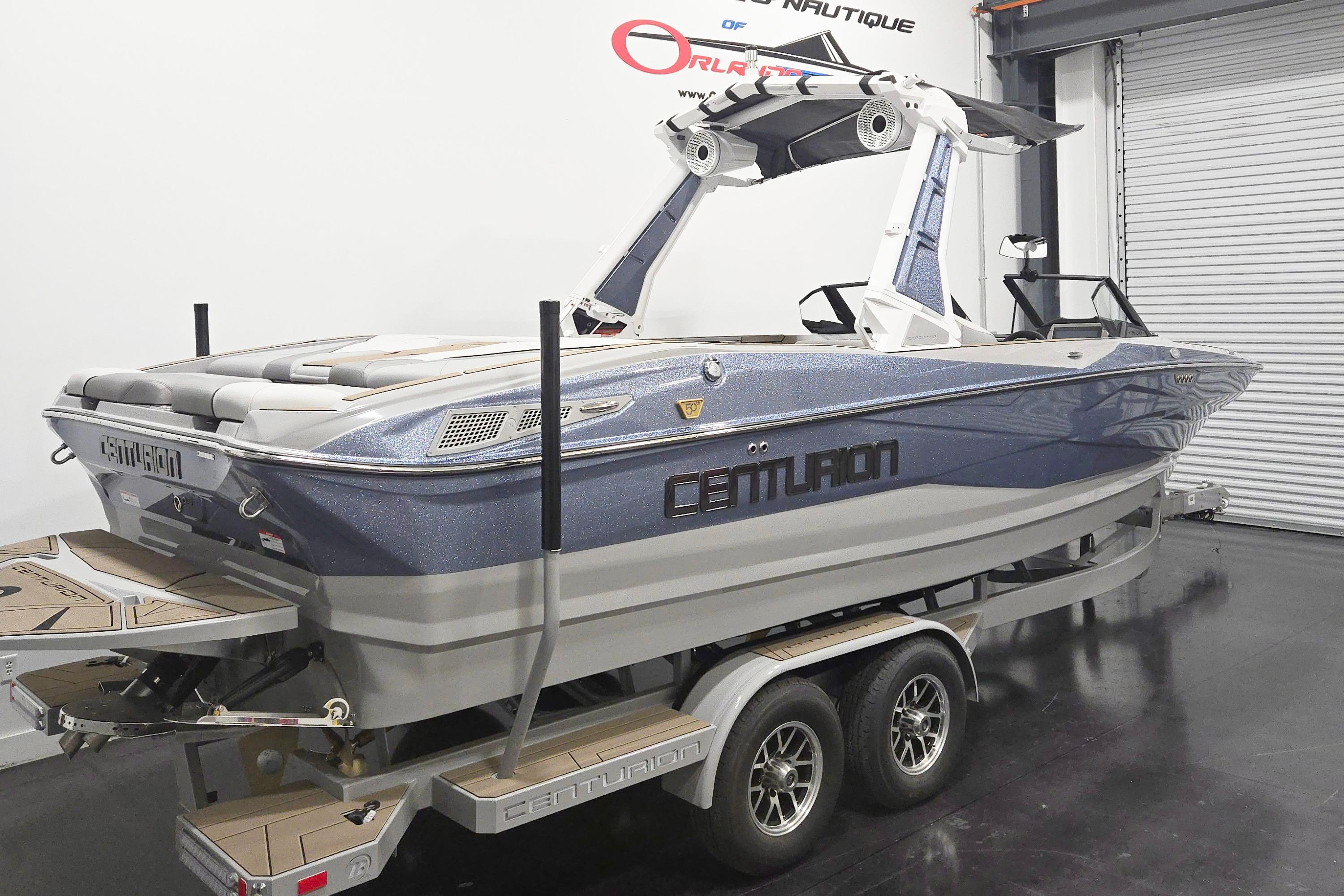 2026 Centurion Nv243 boat on trailer in showroom, featuring sleek design and modern features.