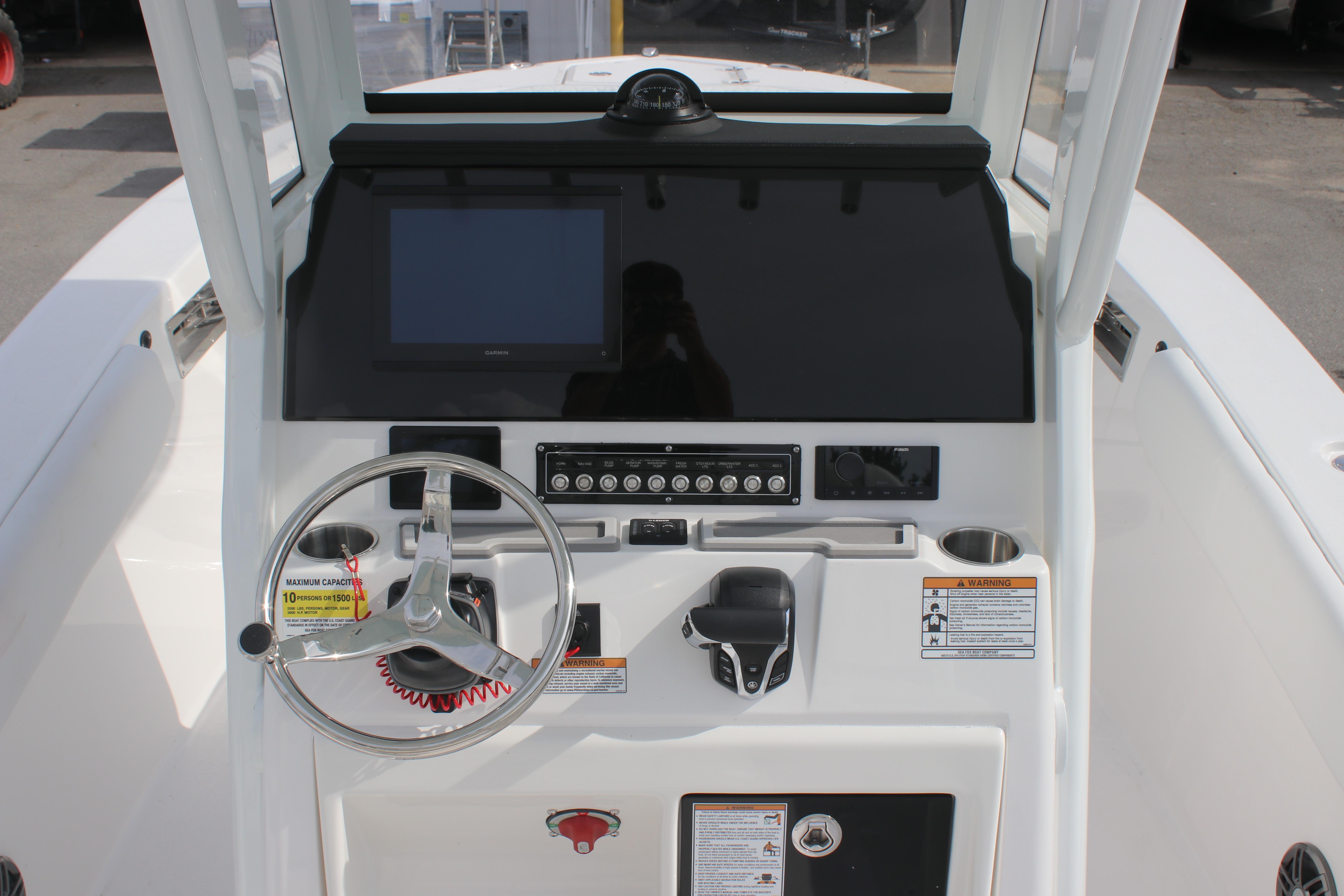 2026 Sea Fox 248 Commander boat dashboard with steering wheel and control panel.