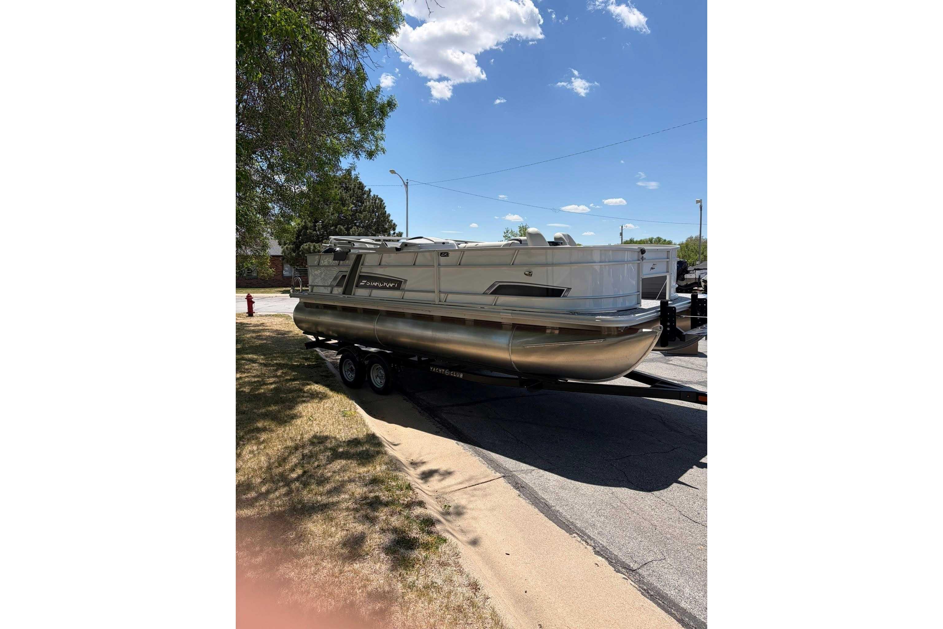 2026 Starcraft EX 22 FD4 pontoon boat on trailer under clear blue sky.