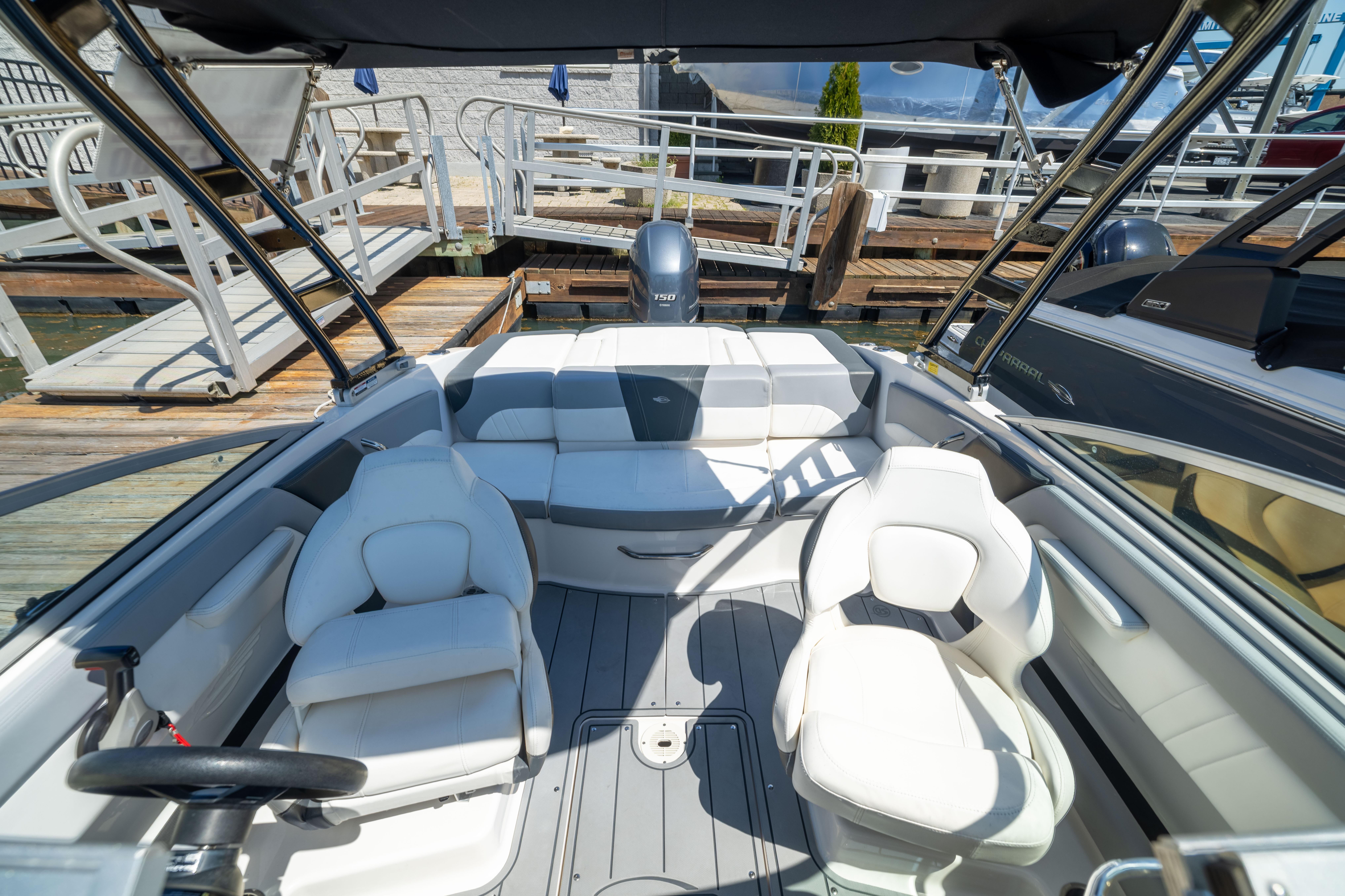 2022 Chaparral 21 SSi OB boat interior with white seating and sleek design.