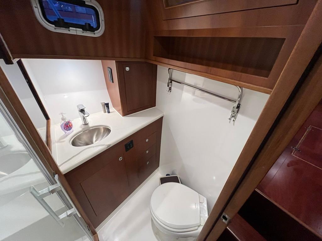 Luxurious bathroom in 2025 Bracewell 41 yacht with modern fixtures and wood cabinetry.
