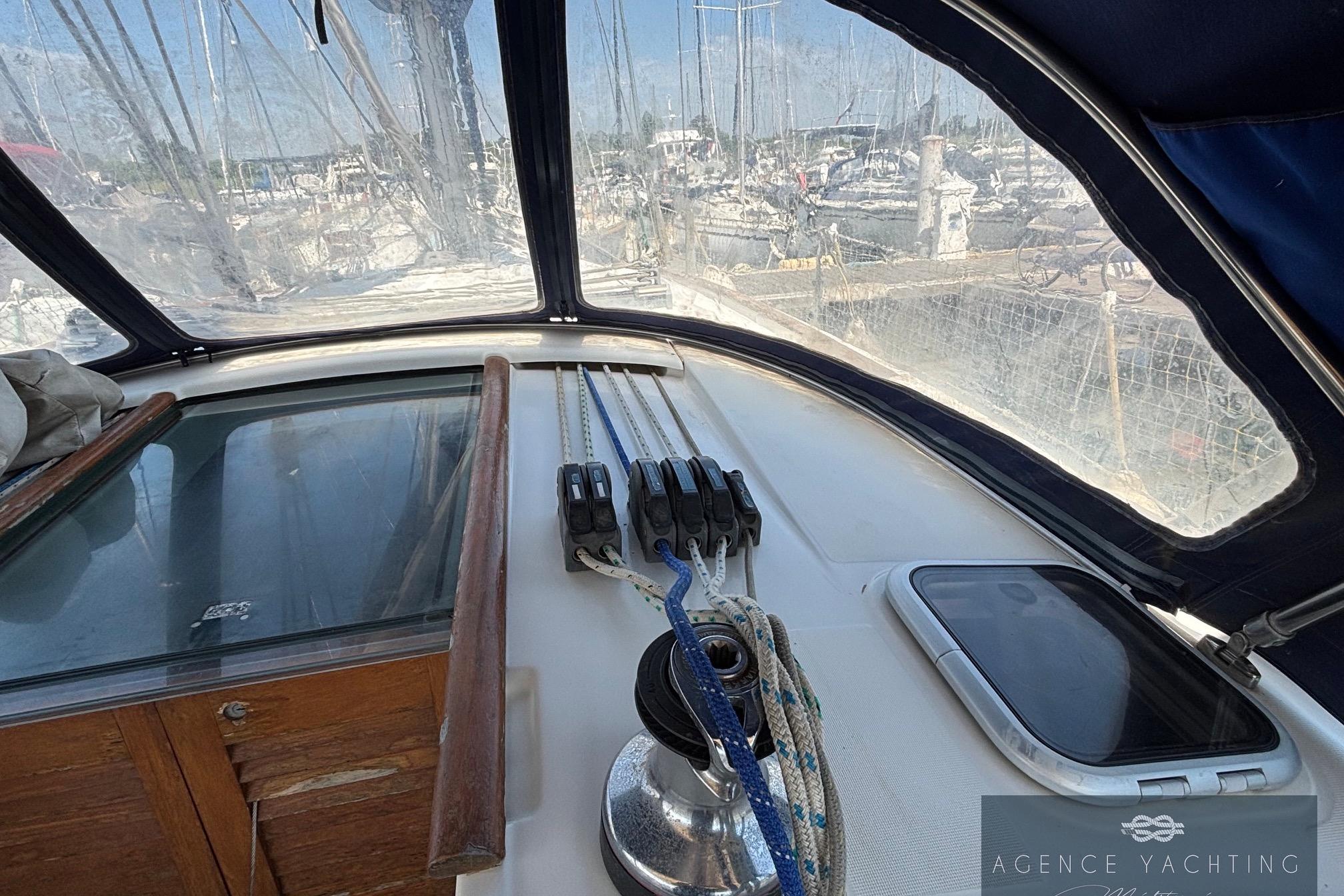Cockpit view of a 2008 Beneteau Oceanis 40 sailboat, showcasing ropes and winch.