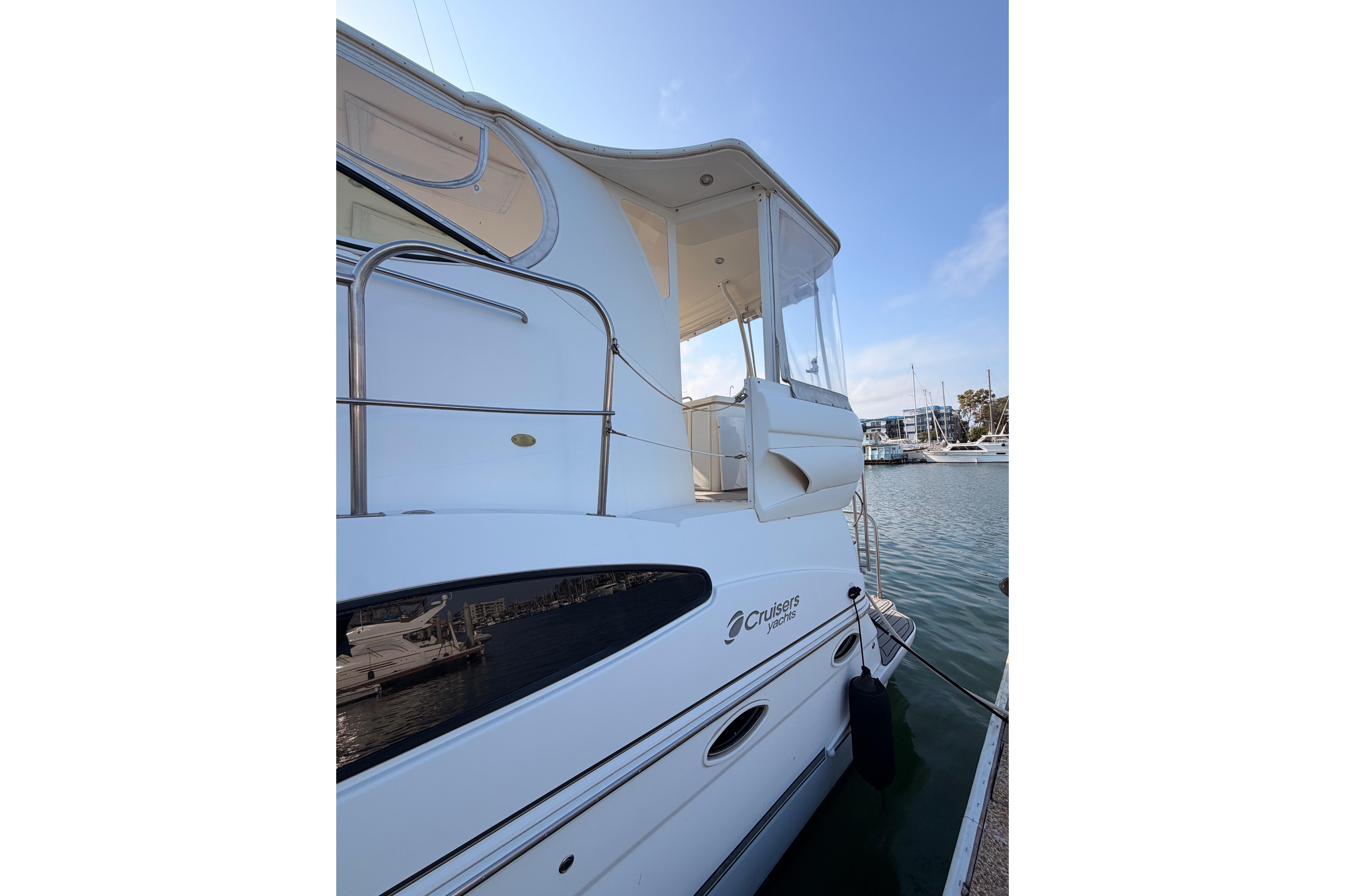 2005 Cruisers Yachts 405 Express Motoryacht docked at marina, side view.